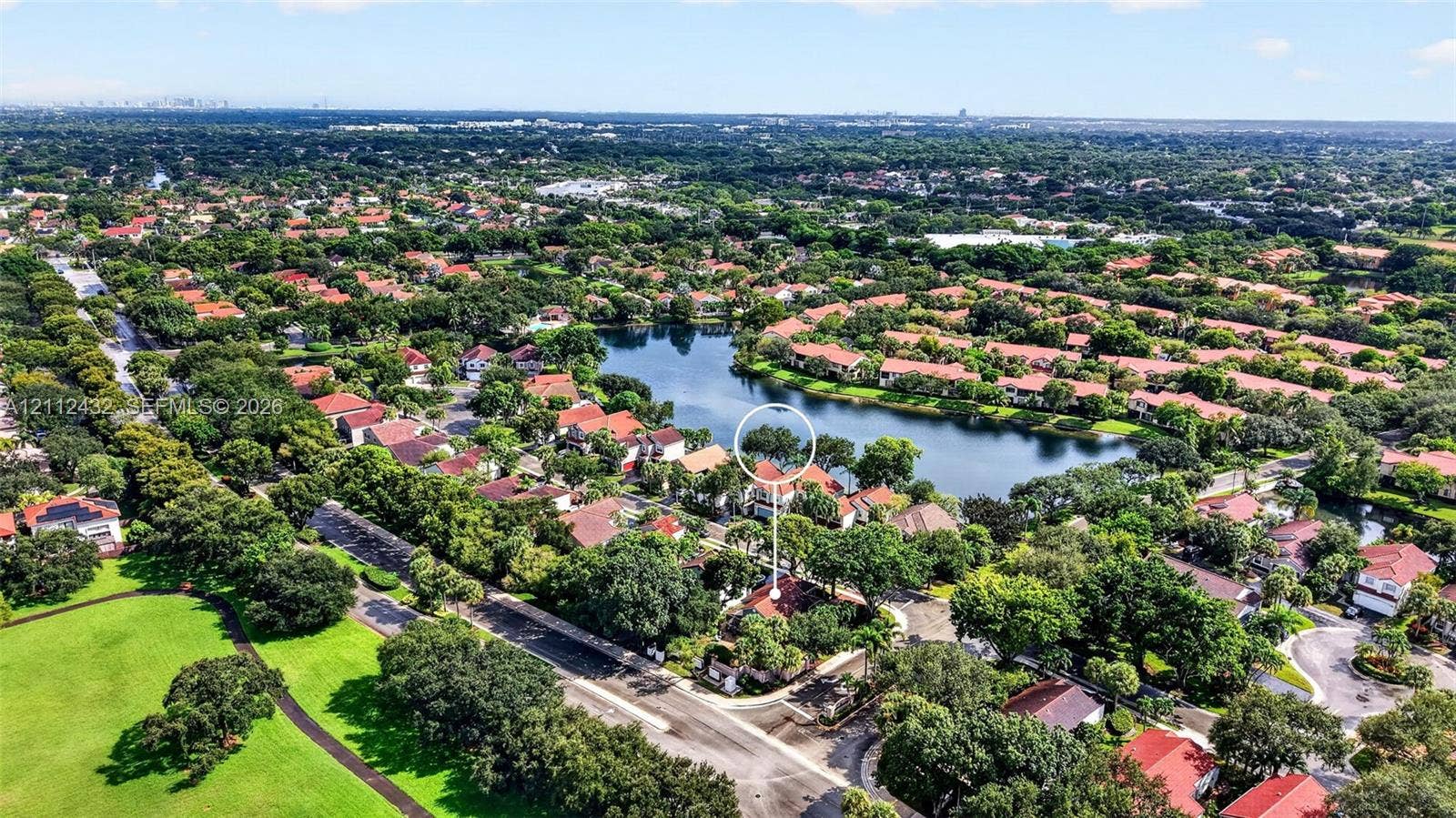 10545 NW 11th Court, Plantation, FL 33322 Check out proximity to Downtown Fort Lauderdale on the left. Aerial perspective featuring a residential property situated on a lakefront lot with mature trees and proximity to open green space