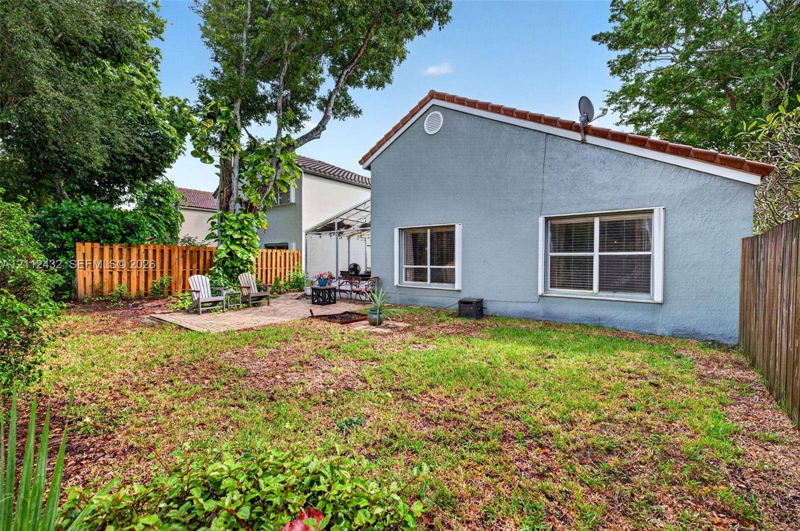 10545 NW 11th Court, Plantation, FL 33322 Rear exterior featuring stucco siding, tile roof, brick paver patio