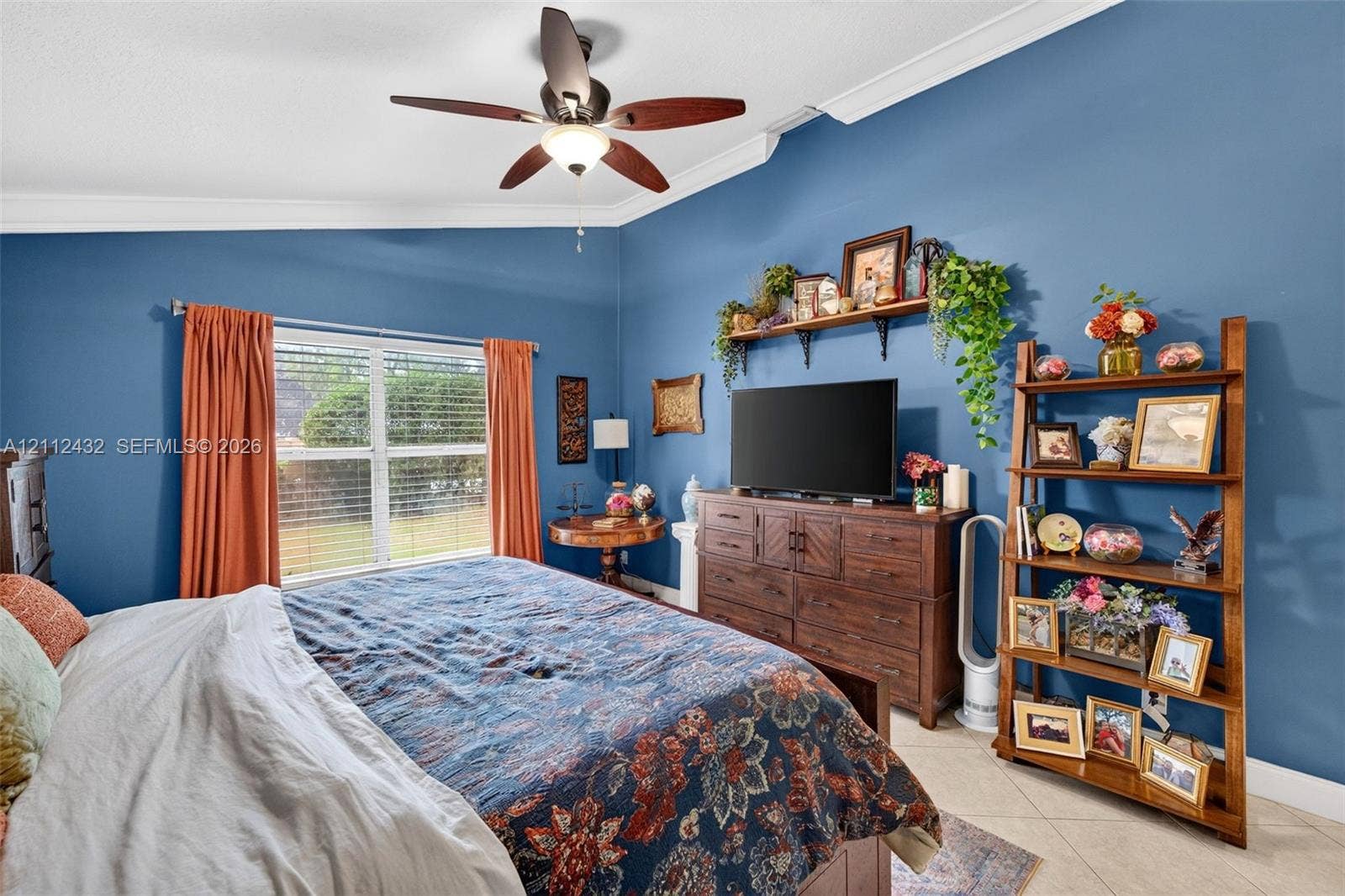 10545 NW 11th Court, Plantation, FL 33322 Vaulted ceilings, crown molding, multi-blade ceiling fan with integrated lighting, and tile flooring