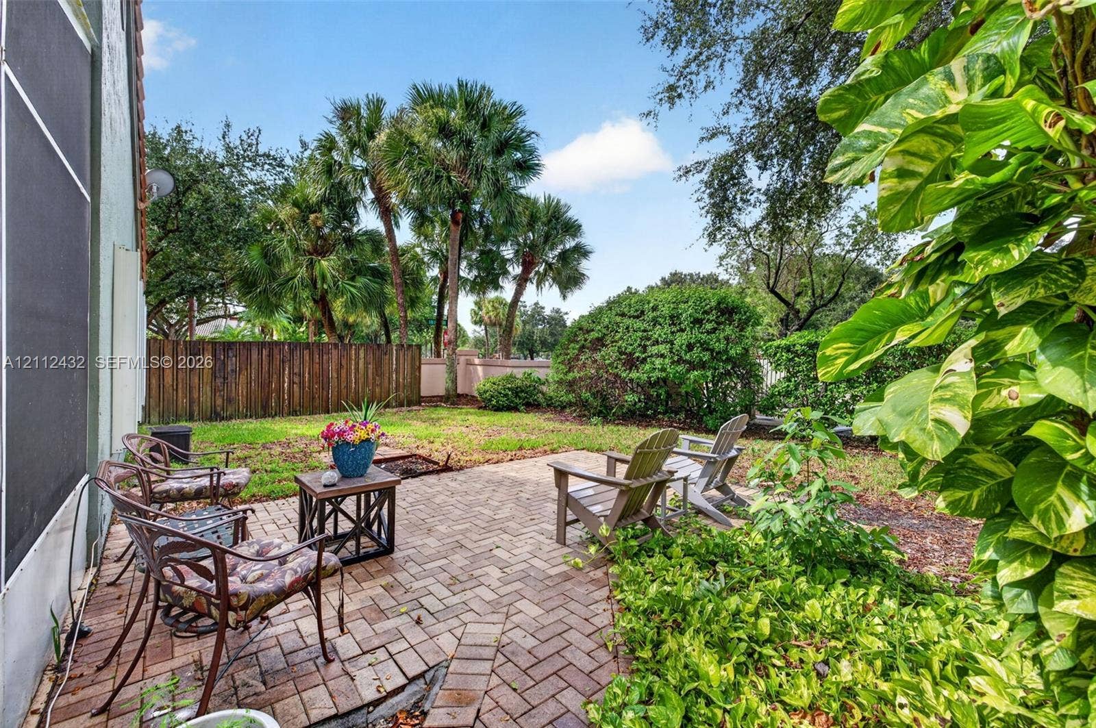10545 NW 11th Court, Plantation, FL 33322 Brick-paver patio featuring mature palm trees, and established landscaping