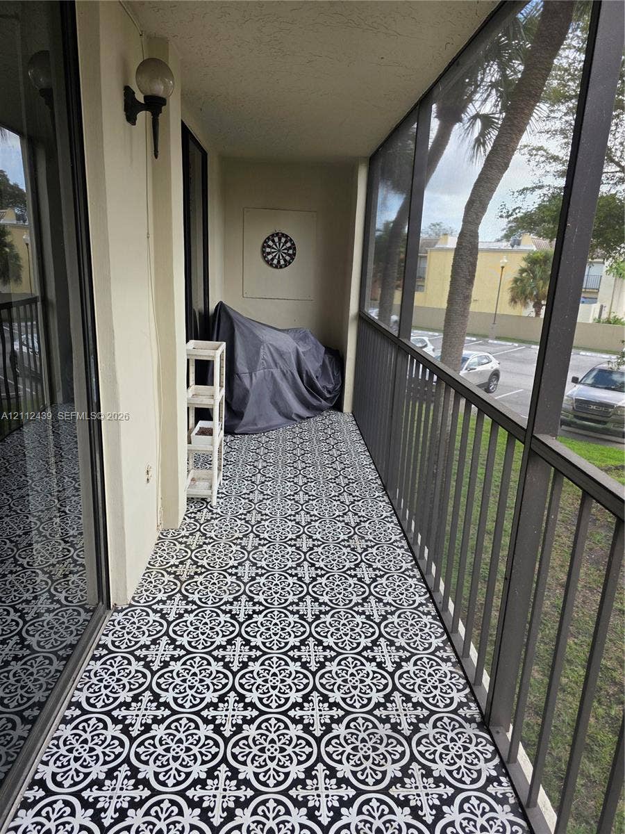 SCREENED BALCONY WITH STORAGE ROOM