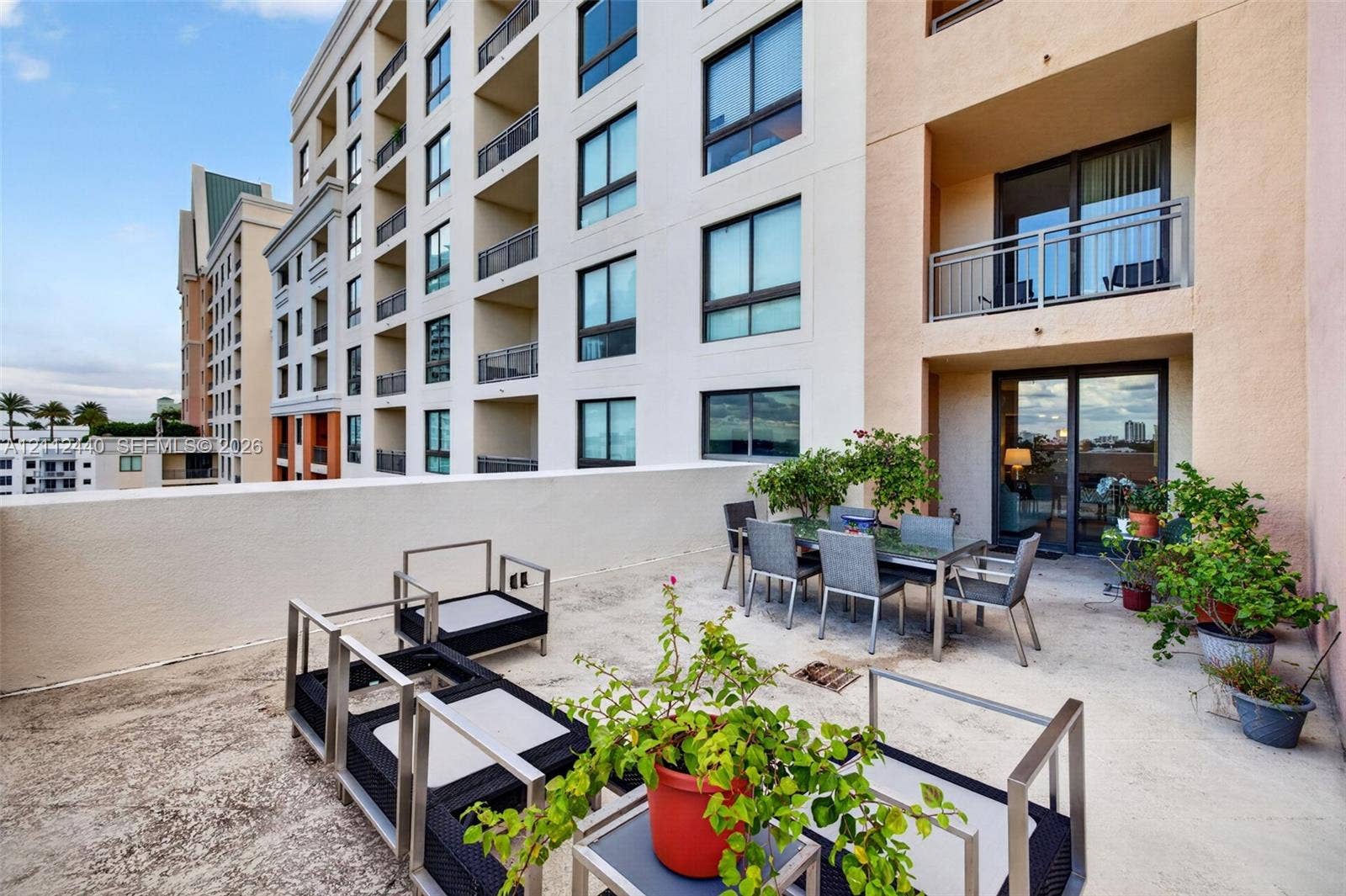 110 N Federal Highway, #914, Fort Lauderdale, FL 33301 Expansive private terrace featuring a solid-surface floor, perimeter concrete walls, and large glass-panel sliding doors