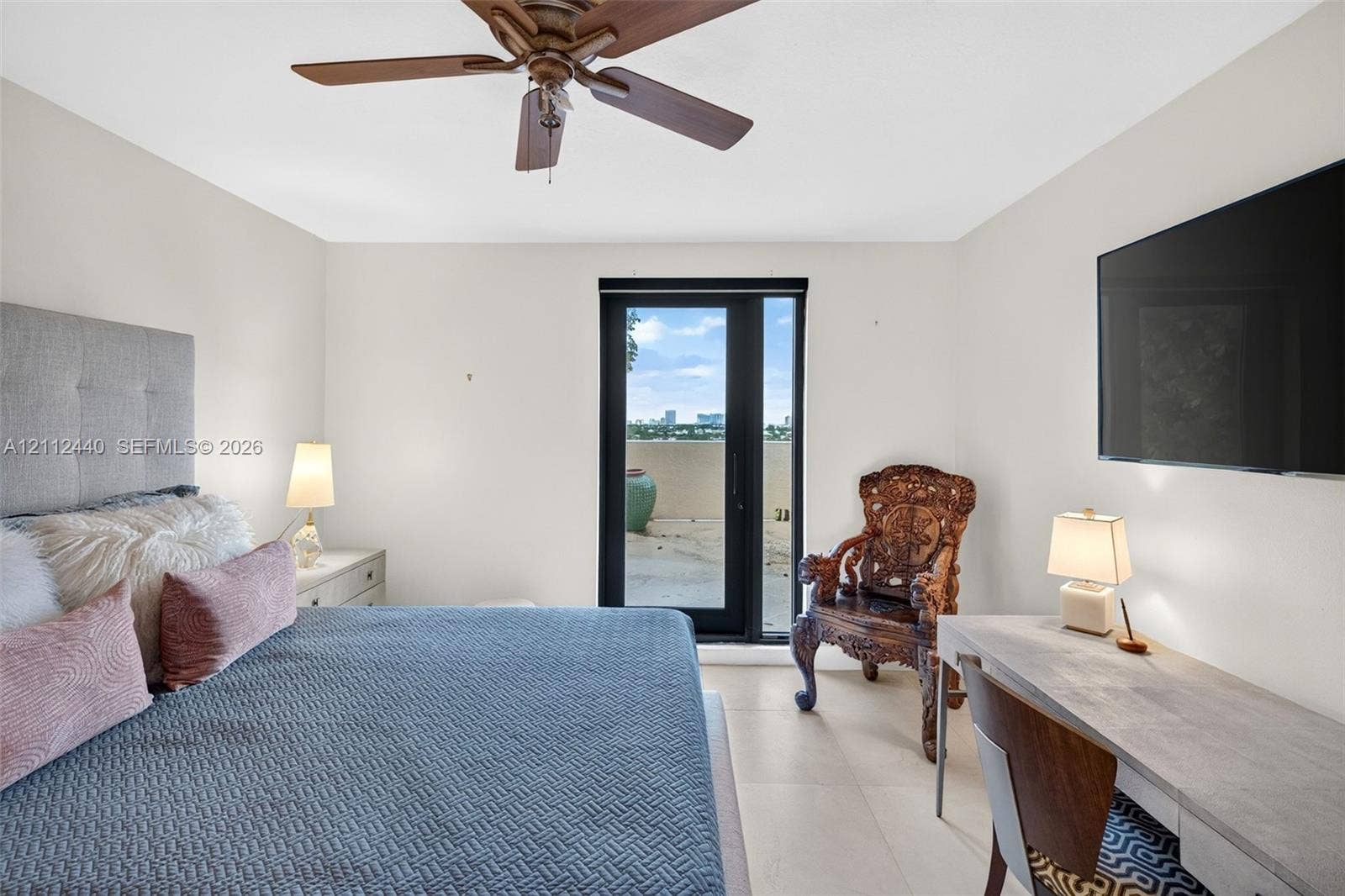 110 N Federal Highway, #914, Fort Lauderdale, FL 33301 Neutral-toned interior featuring large-format porcelain flooring, a ceiling fan with integrated lighting, and a glass-paneled door opening to an oversized exterior terrace