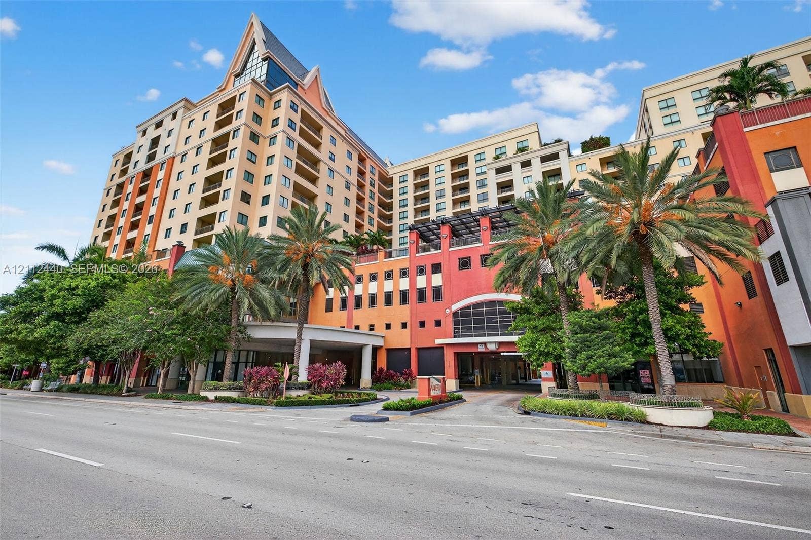 110 N Federal Highway, #914, Fort Lauderdale, FL 33301 High-rise building featuring private balconies, a porte-cochre entryway, and mature palm tree landscaping