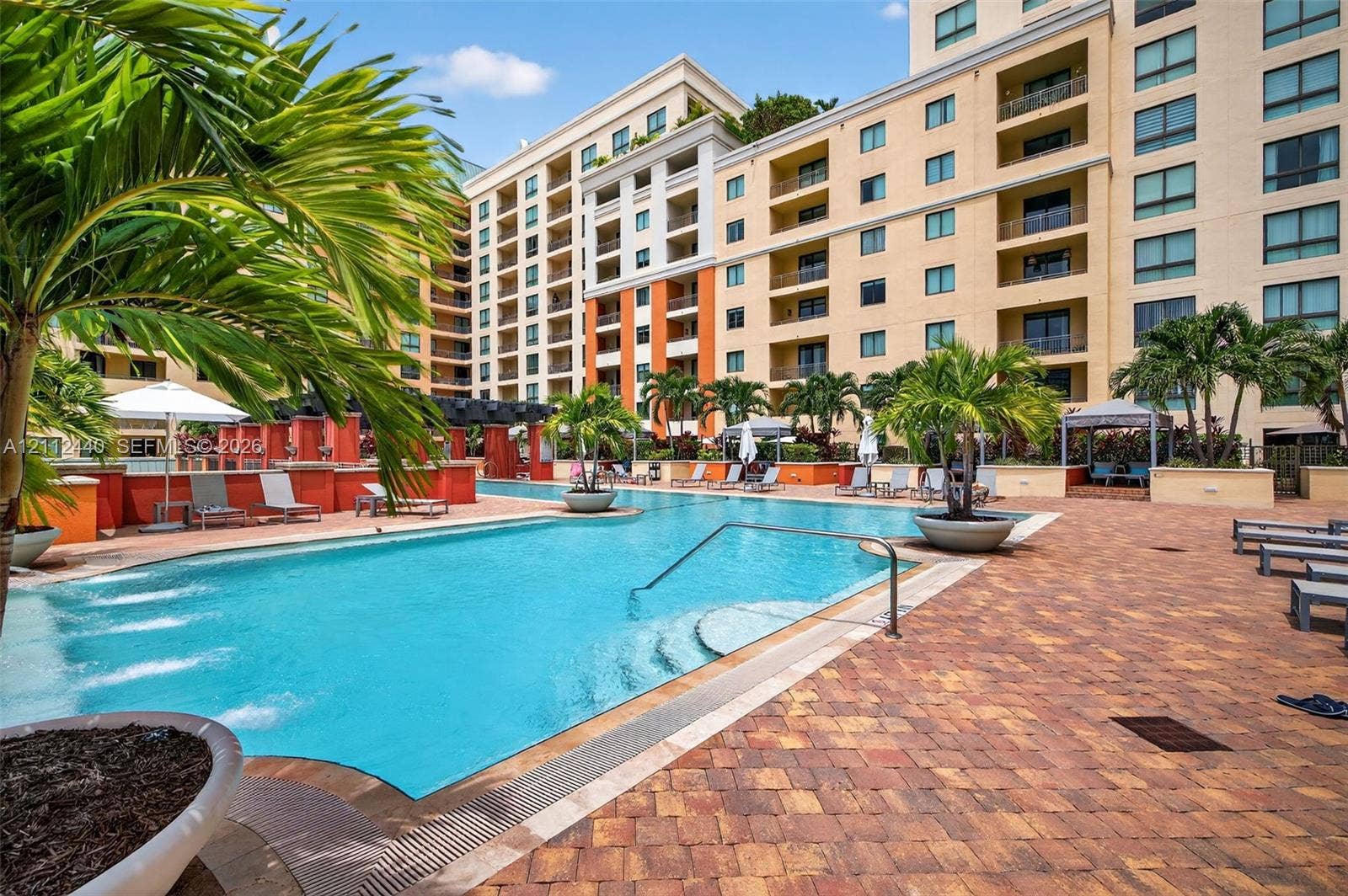 110 N Federal Highway, #914, Fort Lauderdale, FL 33301 Swimming pool featuring a sun shelf entry, decorative water fountains, paver patio surround, and integrated planters
