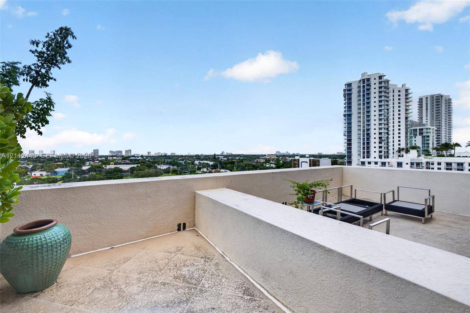 110 N Federal Highway, #914, Fort Lauderdale, FL 33301 Spacious outdoor terrace off the primary bedroom featuring a concrete floor, stone-texture finish, and wide perimeter parapet walls