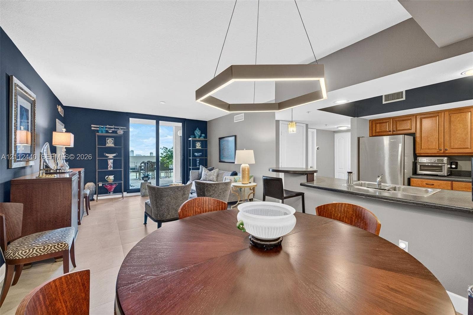 110 N Federal Highway, #914, Fort Lauderdale, FL 33301 Open-concept area featuring porcelain flooring, kitchen breakfast bar - upgraded wooden cabinetry, and sliding glass doors to the huge terrace (chandelier does not convey)