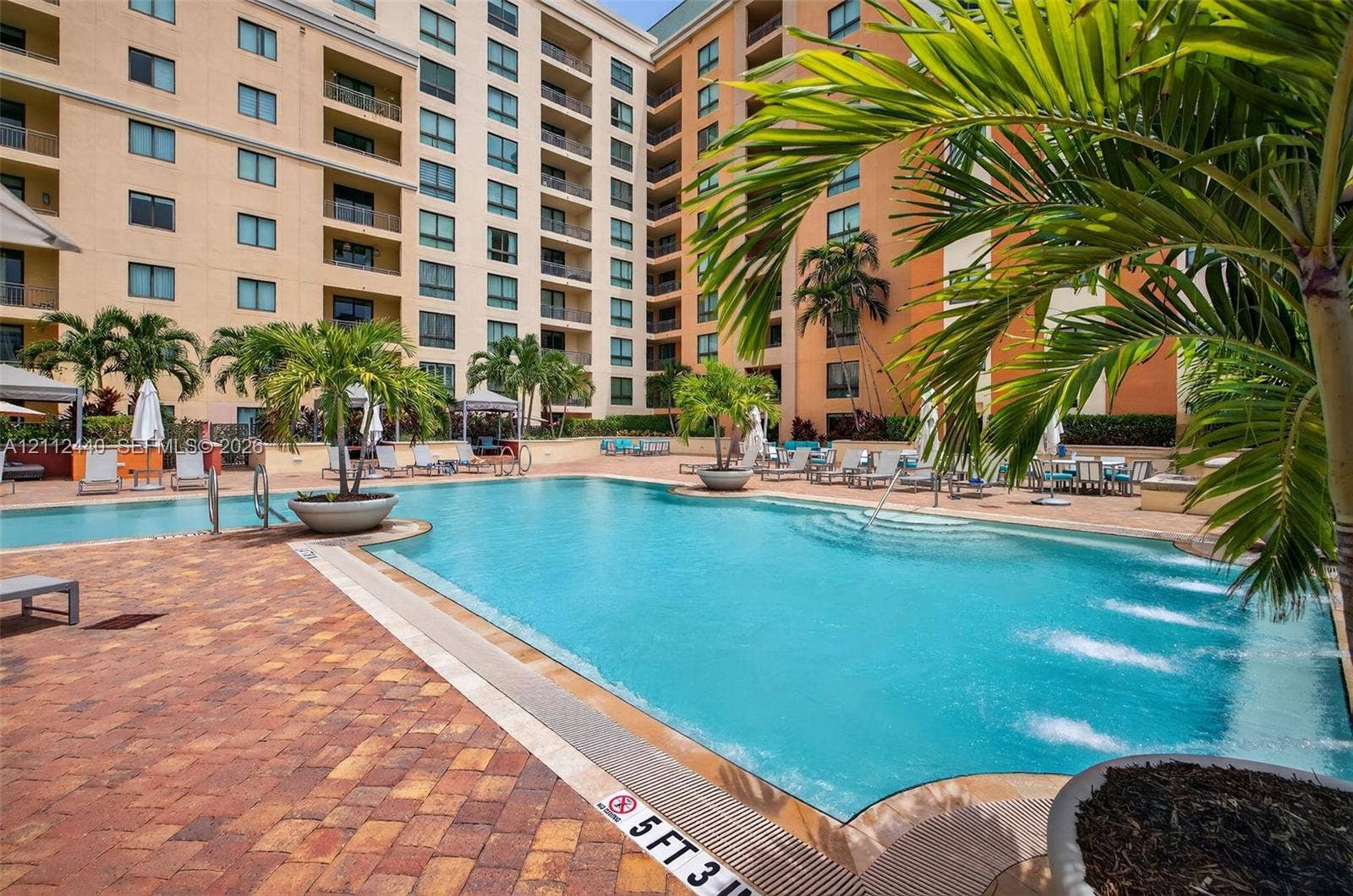 110 N Federal Highway, #914, Fort Lauderdale, FL 33301 Swimming pool featuring a water feature, stone paver decking, and integrated planters