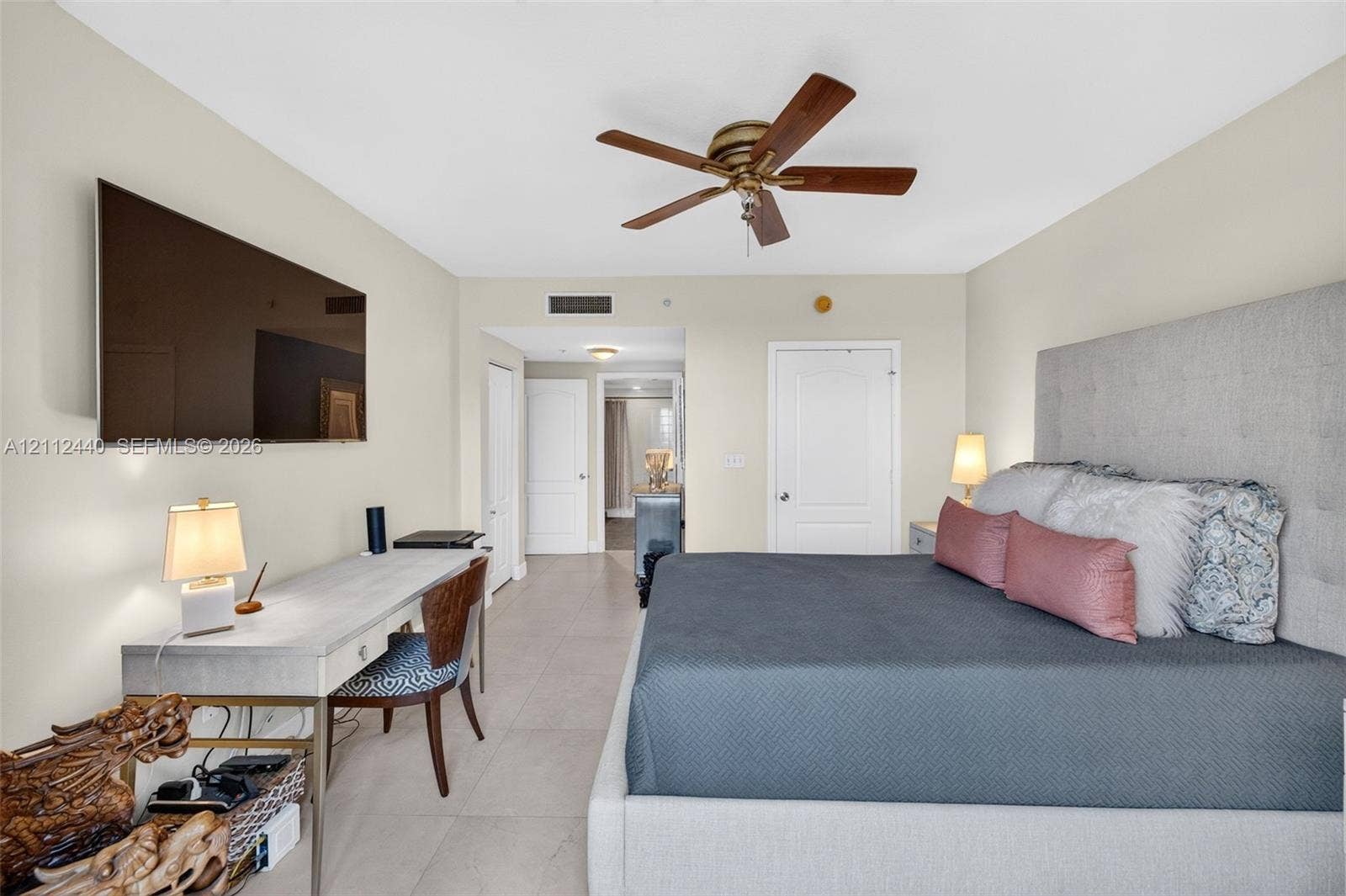 110 N Federal Highway, #914, Fort Lauderdale, FL 33301 Neutral-toned room featuring large-format porcelain flooring, a five-blade ceiling fan with an integrated light fixture, and two separate closets