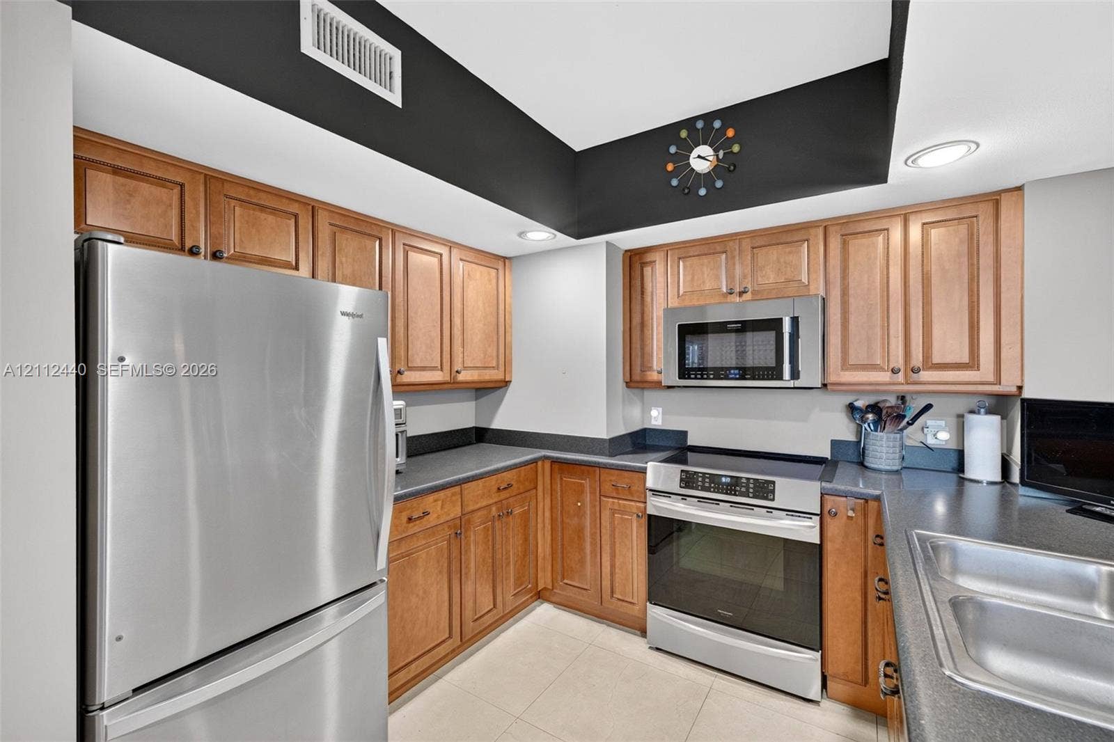 110 N Federal Highway, #914, Fort Lauderdale, FL 33301 Kitchen featuring upgraded wood cabinets, stainless appliances, dark countertops, recessed lighting, and porcelain flooring