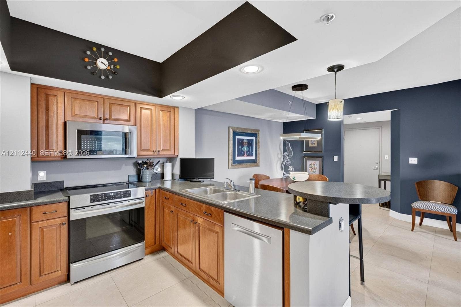 110 N Federal Highway, #914, Fort Lauderdale, FL 33301 Kitchen featuring upgraded wood cabinetry, stainless appliances, dark countertops, a built-in peninsula, and recessed lighting