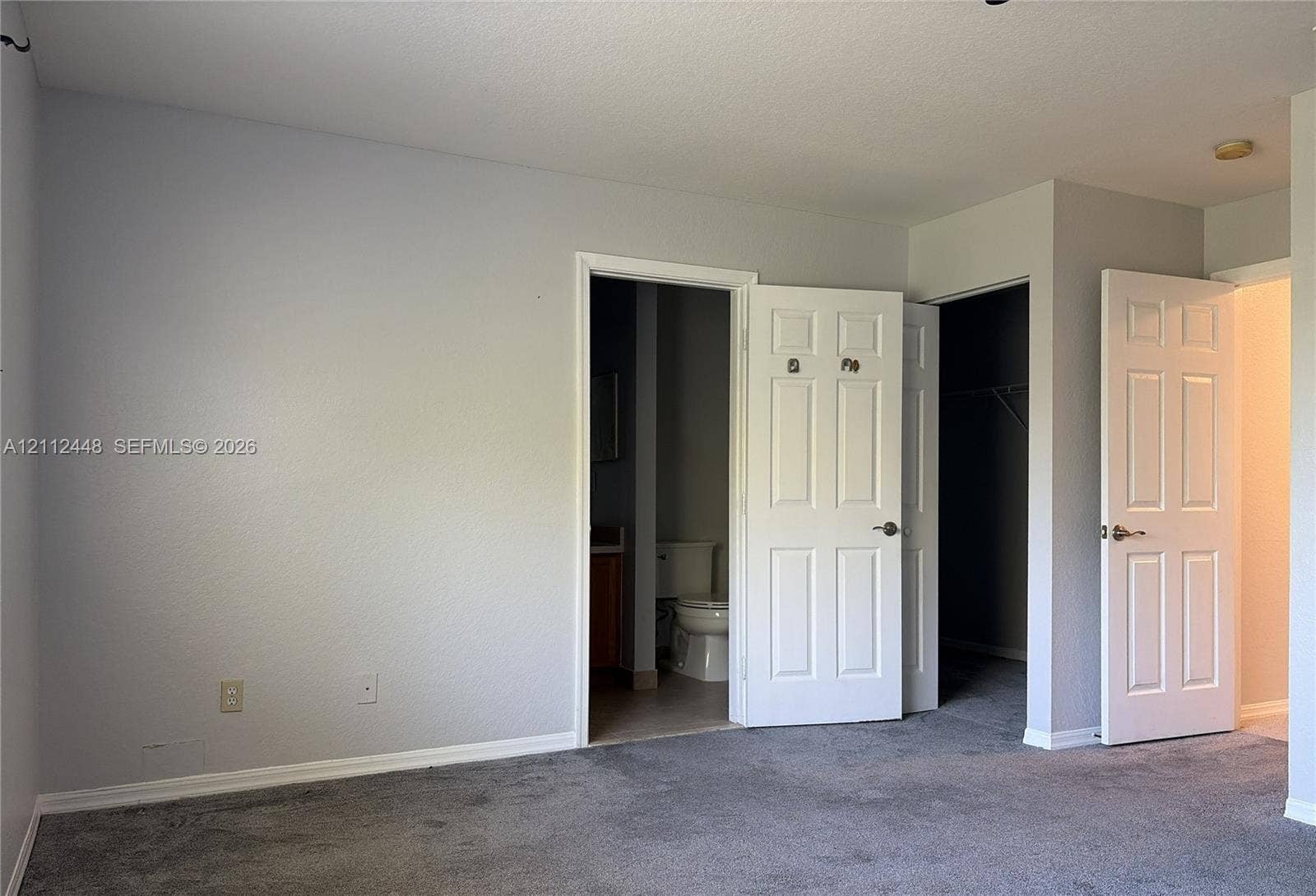 2007 SW Marblehead Way, Port St Lucie, FL 34953 Neutral grey wall paint, wall-to-wall carpet, and multiple six-panel interior doors