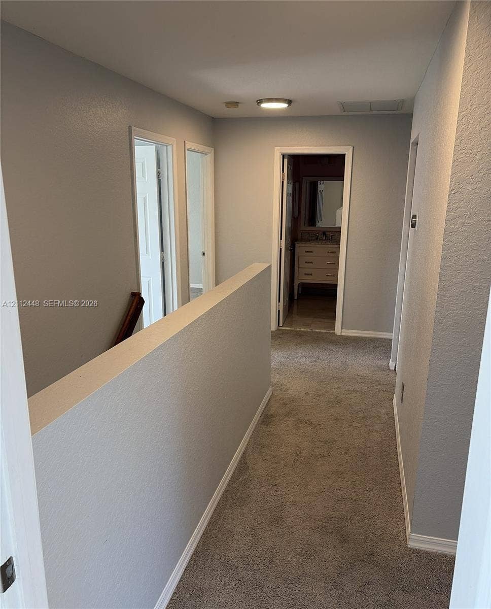 2007 SW Marblehead Way, Port St Lucie, FL 34953 Neutral wall finishes, plush carpeting, ceiling-mounted lighting, and painted door casings