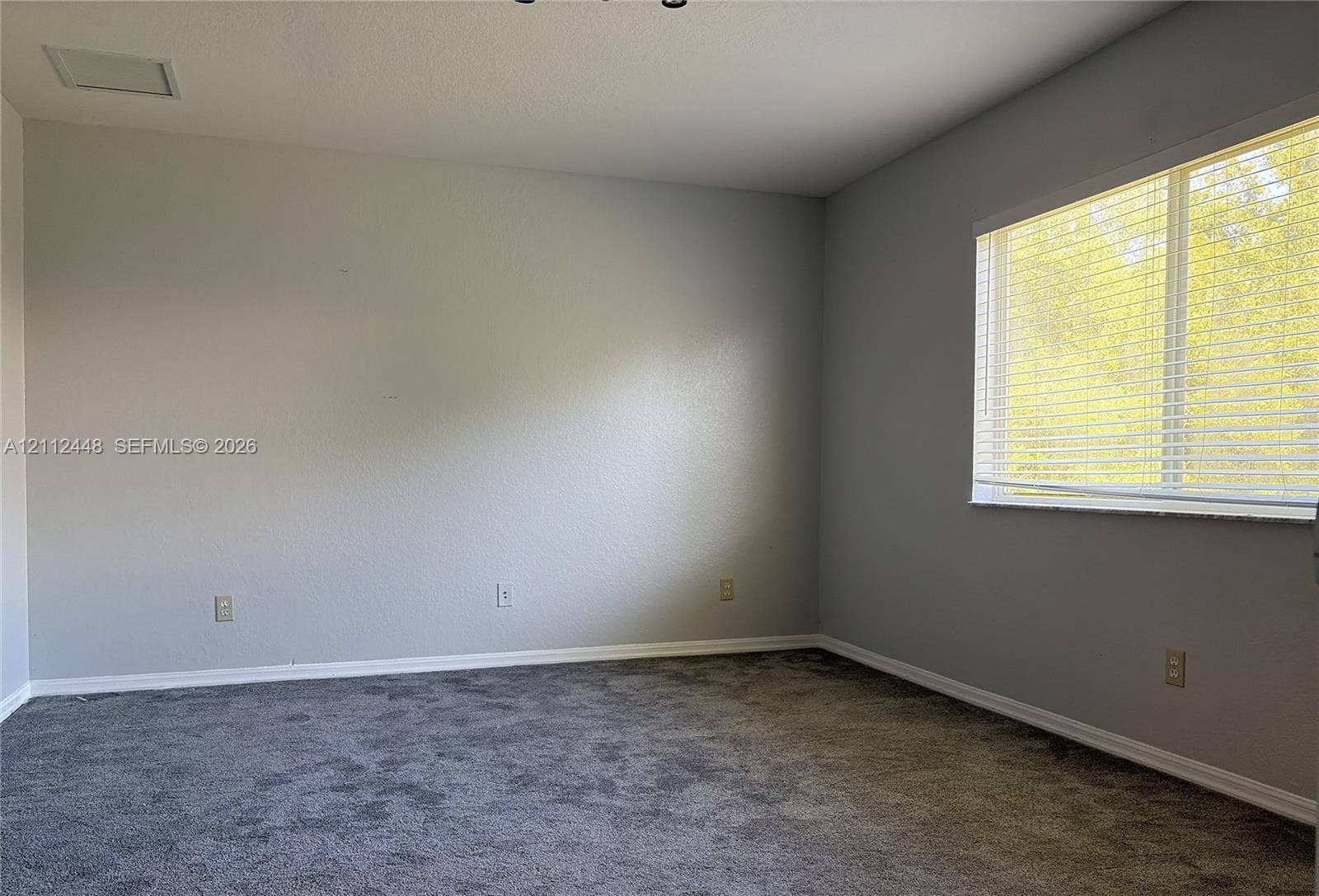 2007 SW Marblehead Way, Port St Lucie, FL 34953 Neutral wall paint, carpeting, and horizontal window blinds