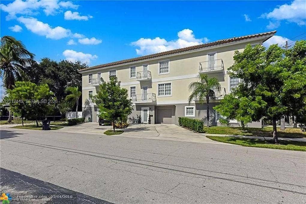 725 SE 14th Court, Fort Lauderdale, FL 33316 Multi-level exterior featuring a tile roof, stucco facade and private balconies.