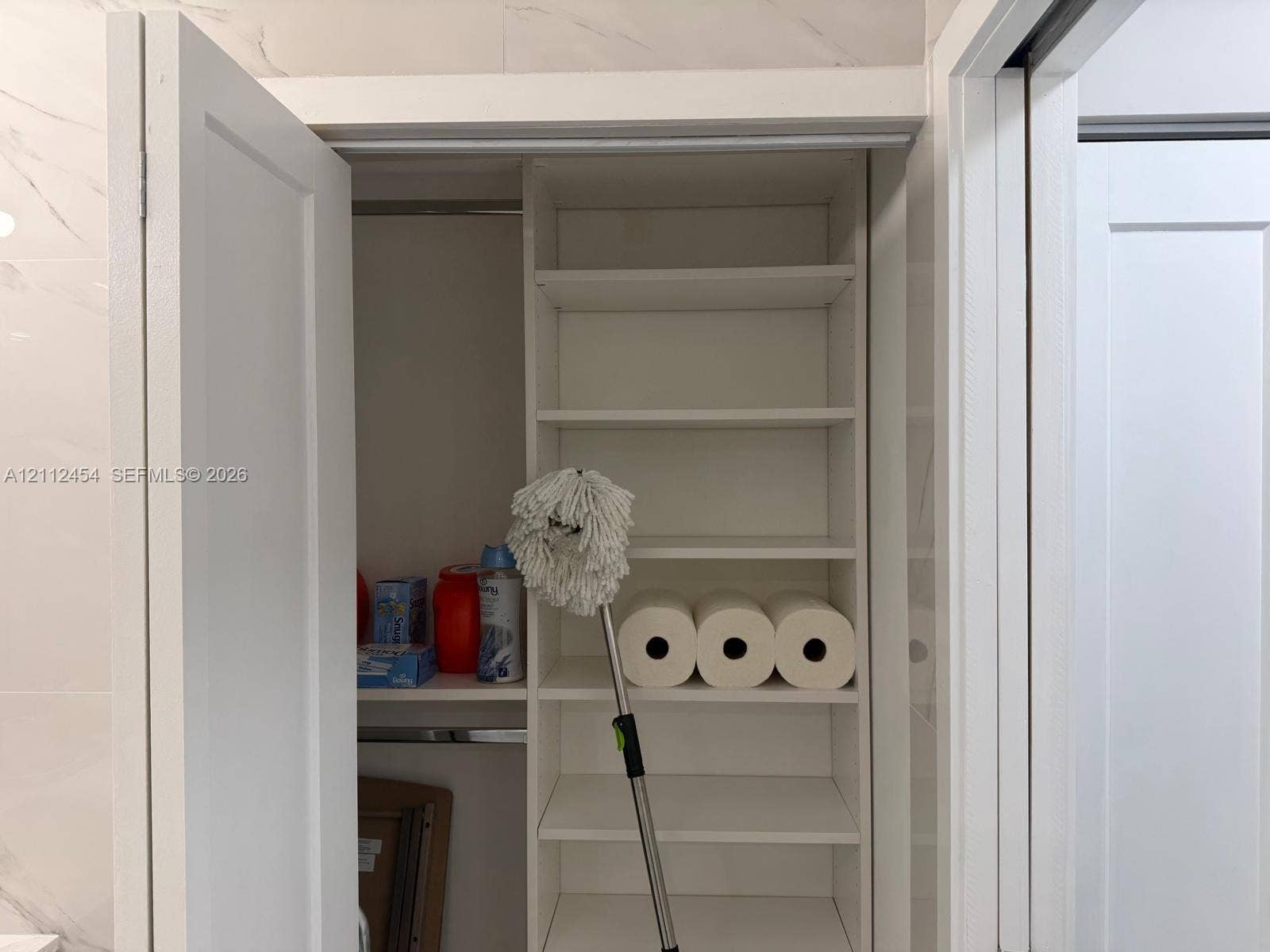 3800 S Ocean Drive, #1601, Hollywood, Hollywood, FL 33019 Built-in storage closet featuring white shelving, a clothing rod, and dual-swing doors