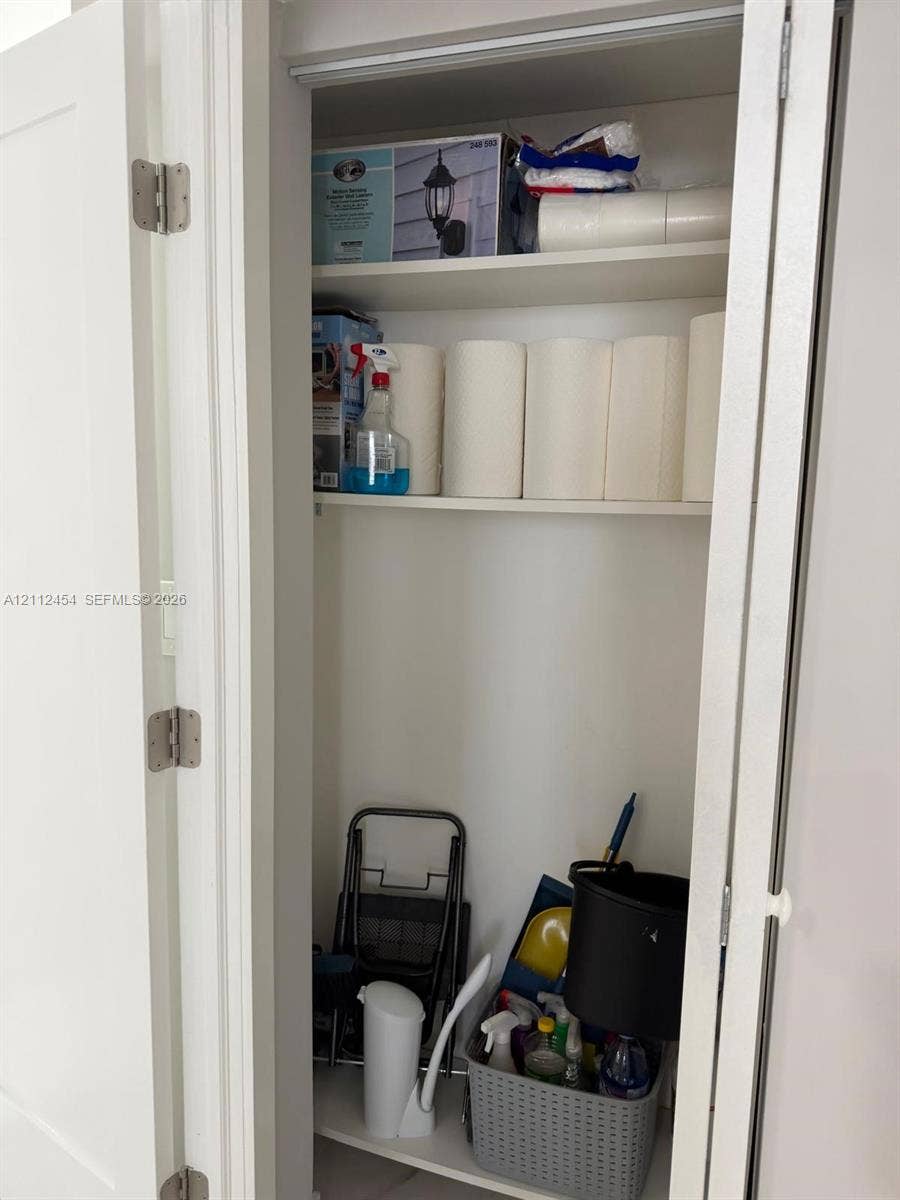 3800 S Ocean Drive, #1601, Hollywood, Hollywood, FL 33019 Storage closet featuring white interior walls, white shelving, and white bifold doors with brushed nickel hinges