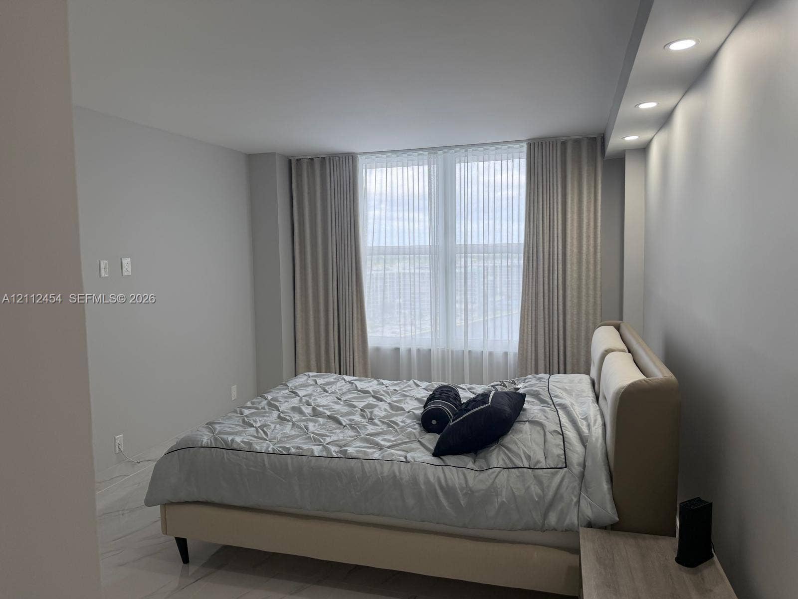 3800 S Ocean Drive, #1601, Hollywood, Hollywood, FL 33019 Large windows with floor-to-ceiling drapery, recessed soffit lighting, and high-gloss tile flooring