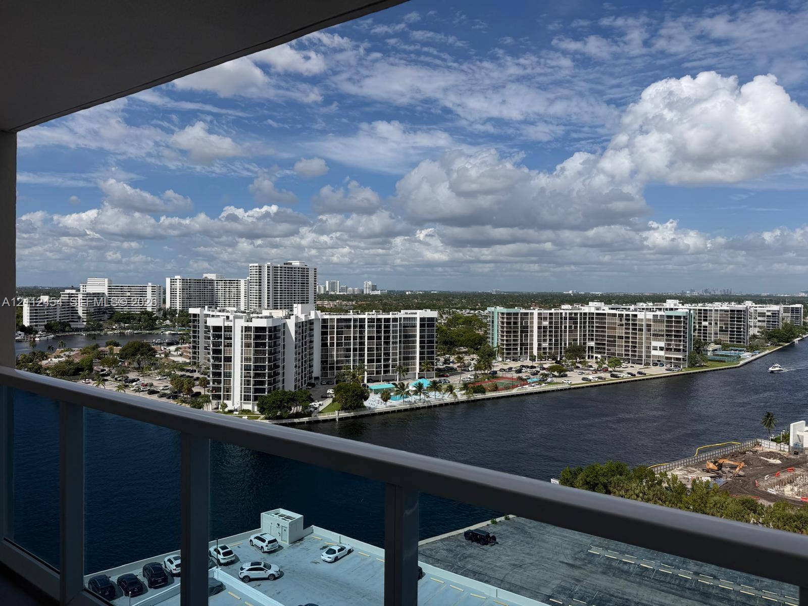 3800 S Ocean Drive, #1601, Hollywood, Hollywood, FL 33019 Covered balcony with a white metal railing overlooking a waterway and high-rise skyline