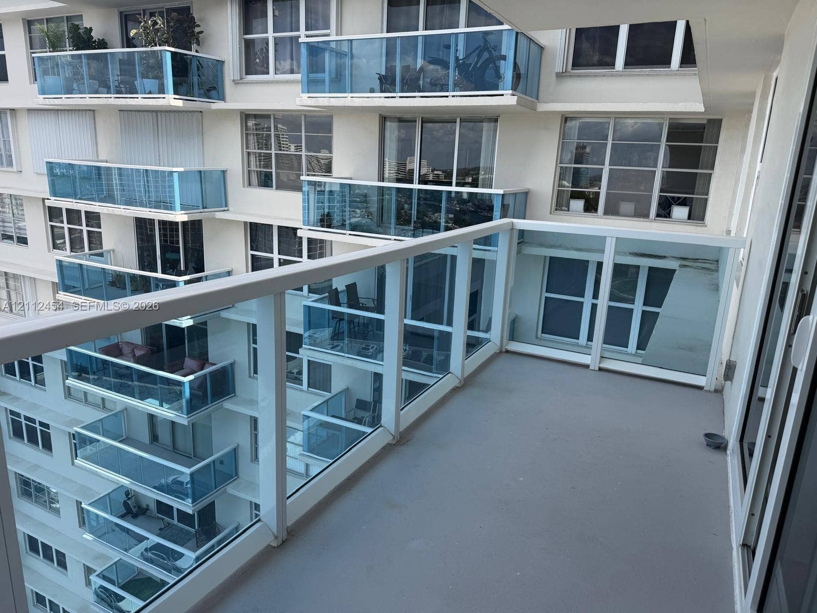 3800 S Ocean Drive, #1601, Hollywood, Hollywood, FL 33019 Private balcony featuring glass panel railings, a concrete floor surface, and large-format exterior window installations