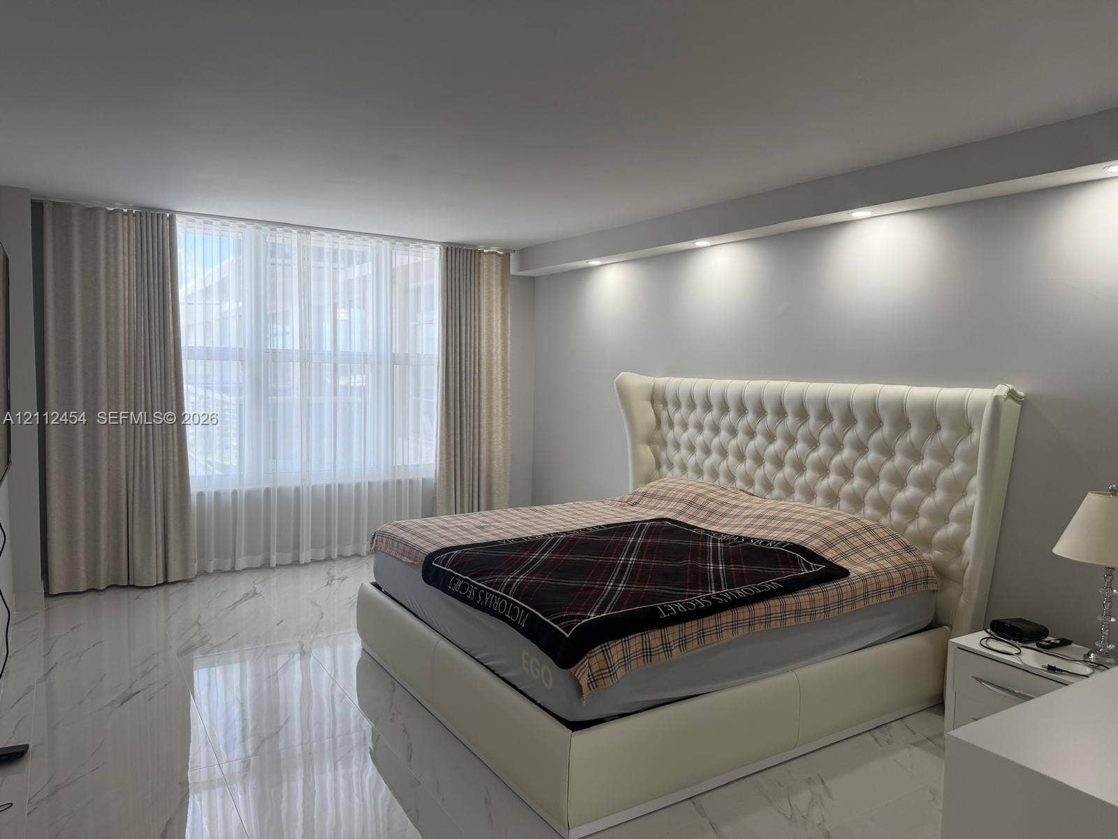 3800 S Ocean Drive, #1601, Hollywood, Hollywood, FL 33019 Large-format tile flooring with a neutral veined finish, floor-to-ceiling windows, and recessed ceiling lighting