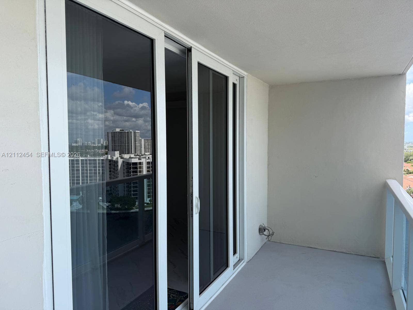 3800 S Ocean Drive, #1601, Hollywood, Hollywood, FL 33019 Private balcony featuring glass-panel railings and white-frame sliding glass doors