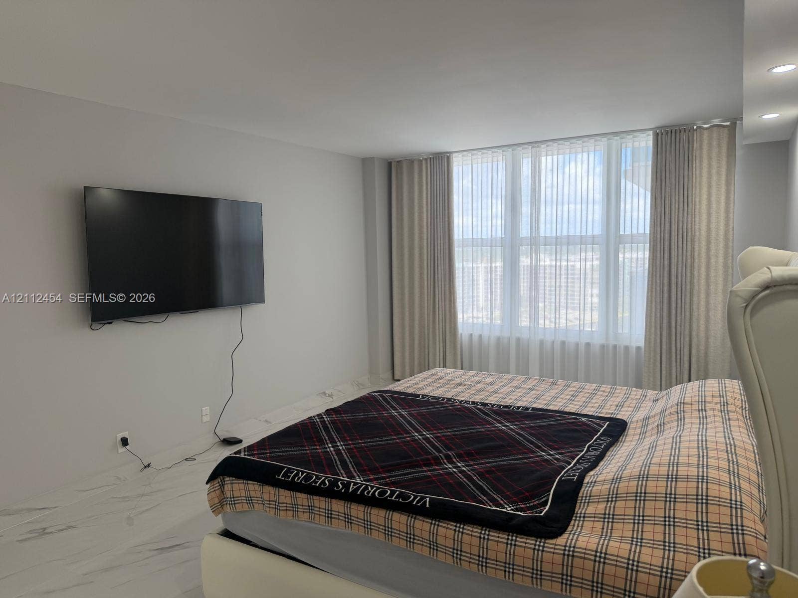 3800 S Ocean Drive, #1601, Hollywood, Hollywood, FL 33019 Spacious room featuring high-gloss large-format tile flooring, floor-to-ceiling windows with vertical blinds, and recessed lighting