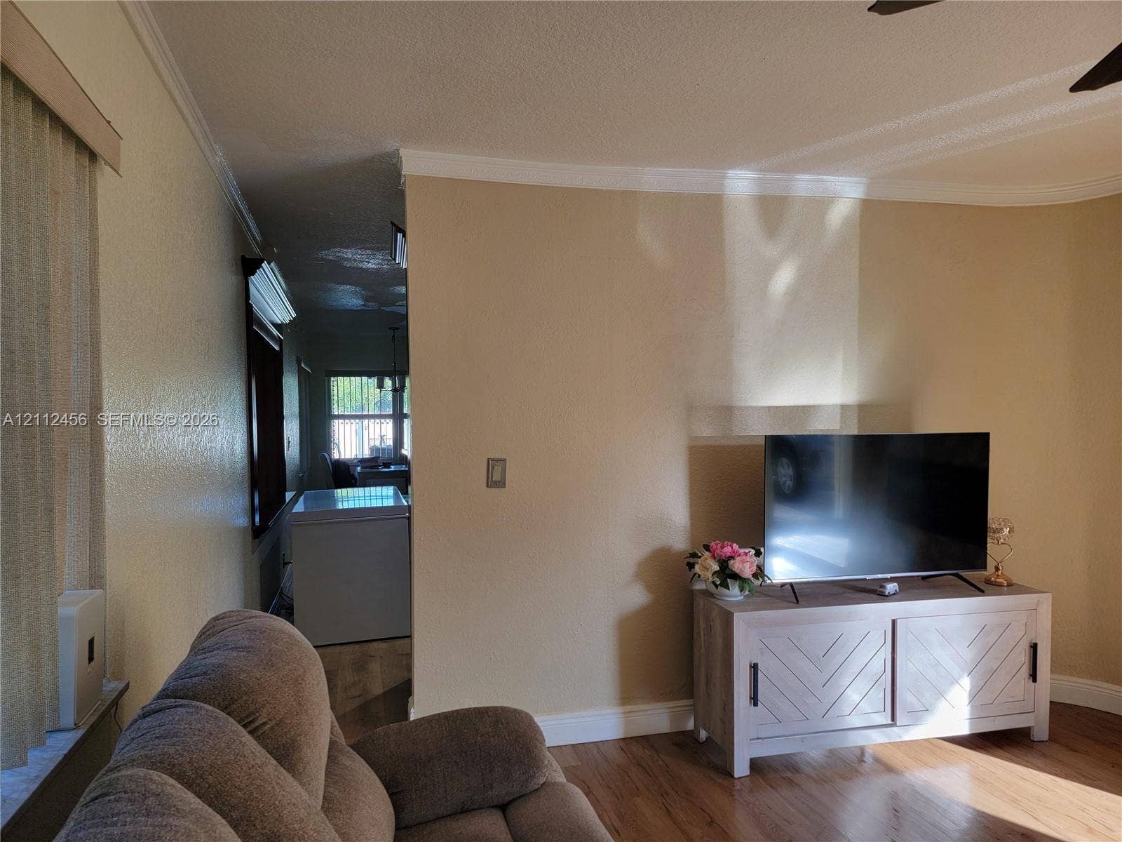3961 NW 110th Avenue, #3961, Coral Springs, Coral Springs, FL 33065 Wood-finish flooring, neutral wall tones, and crown molding