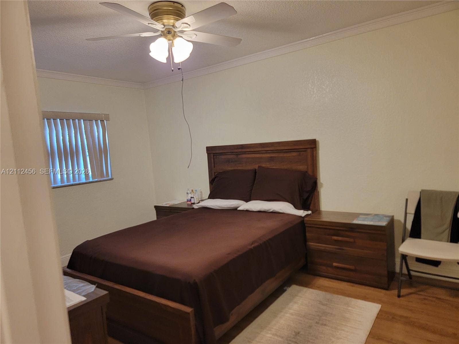 3961 NW 110th Avenue, #3961, Coral Springs, Coral Springs, FL 33065 Room featuring wood-finish flooring, crown molding, and a ceiling fan with integrated lighting
