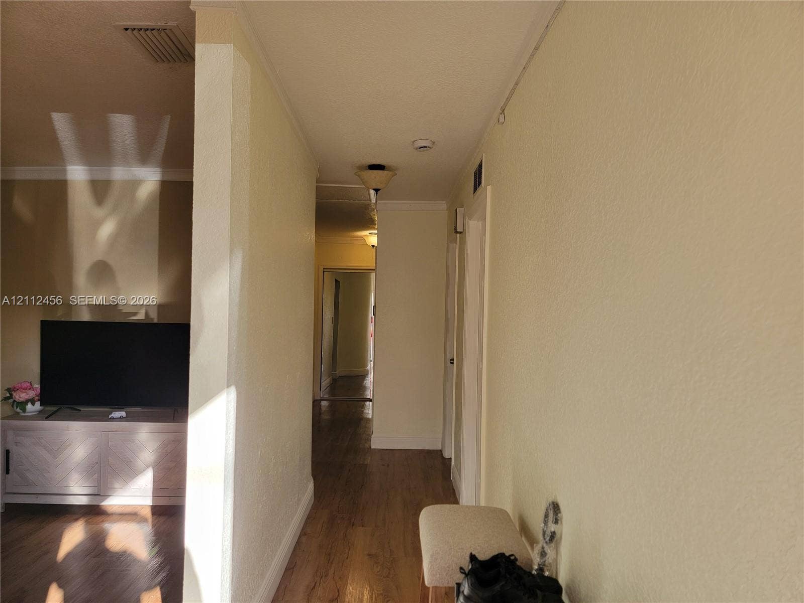 3961 NW 110th Avenue, #3961, Coral Springs, Coral Springs, FL 33065 Interior hallway featuring wood-finish flooring, textured wall surfaces, and flush-mount ceiling lighting