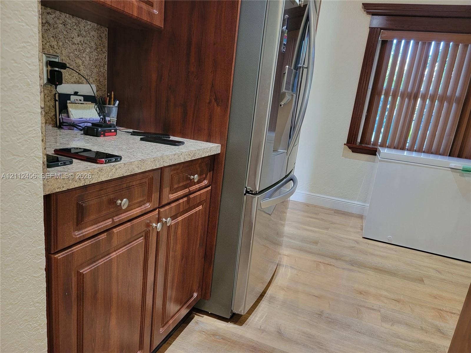 3961 NW 110th Avenue, #3961, Coral Springs, Coral Springs, FL 33065 Wood-finish cabinetry with stone-patterned countertops, wood-finish flooring, and natural wood window casing