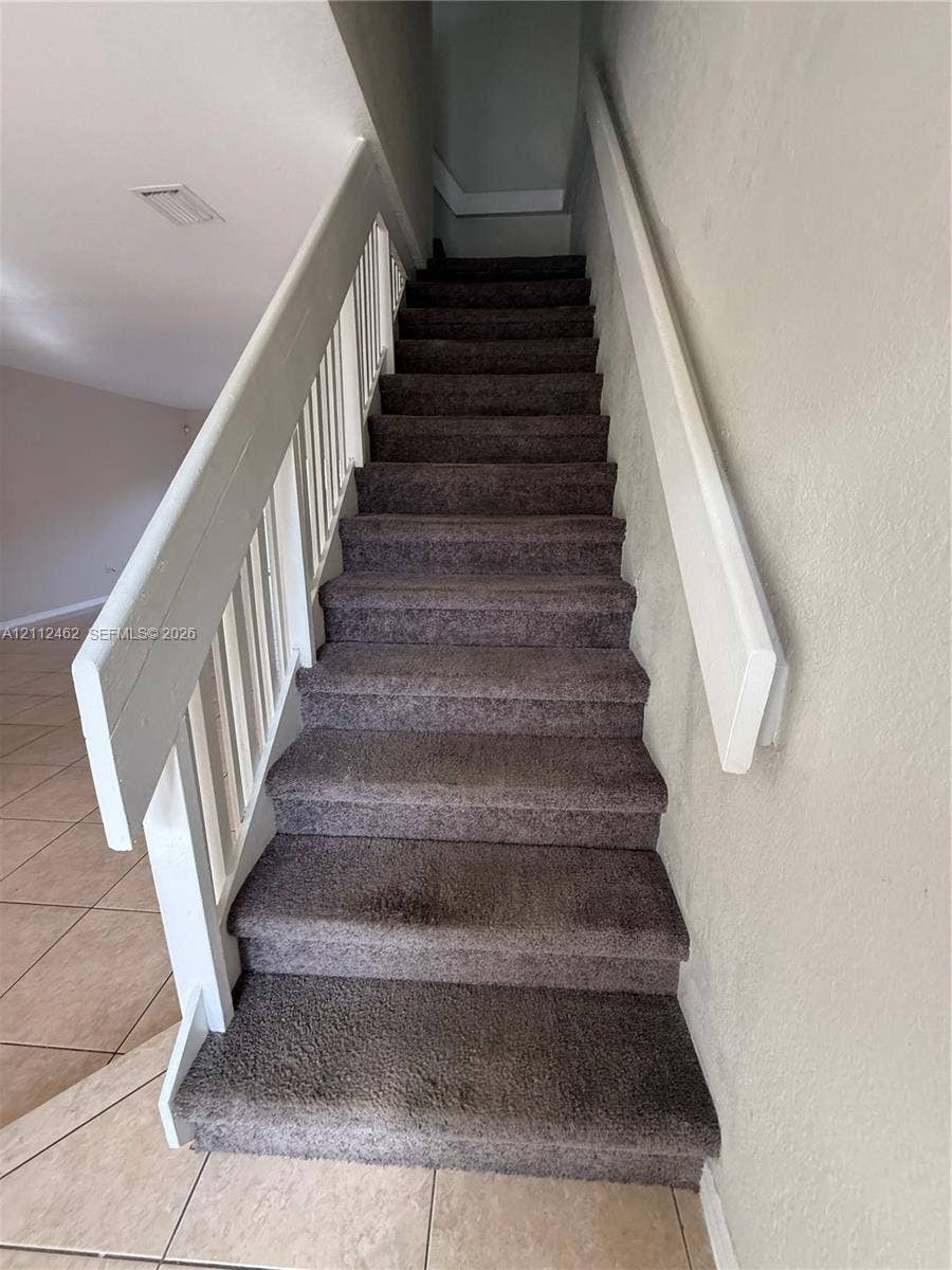 20439 NW 15th Avenue, #9, Miami Gardens, Miami Gardens, FL 33169 Staircase featuring wall-to-wall carpeting, a white wood railing, and a coordinating white handrail