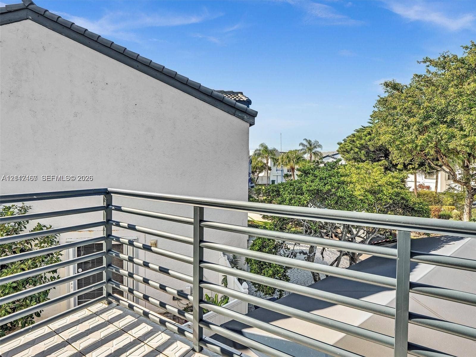 250 NE 212th Street, Miami, Miami, FL 33179 Elevated balcony featuring a metal horizontal-bar railing and tiled flooring