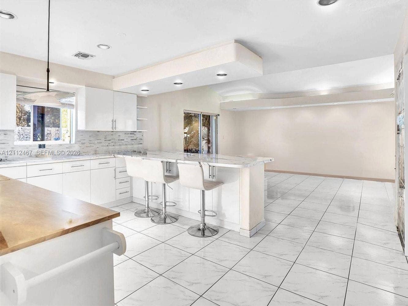 250 NE 212th Street, Miami, Miami, FL 33179 Kitchen featuring white cabinetry, stone-finish countertops, stone tile backsplash, recessed lighting, and tile flooring