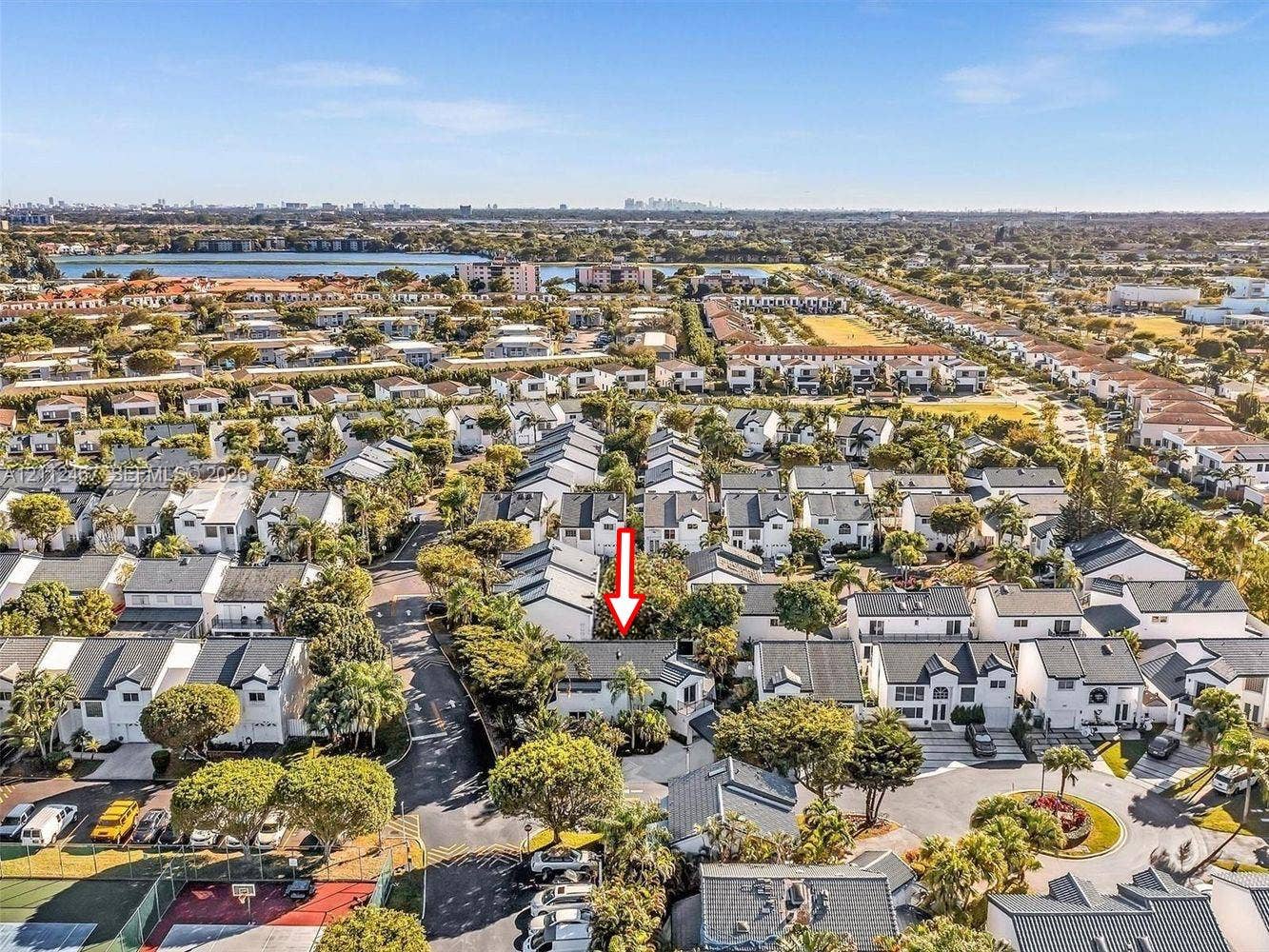 250 NE 212th Street, Miami, Miami, FL 33179 Aerial perspective of a multi-family residential community featuring mature landscaping, paved roadways, and proximity to regional water features