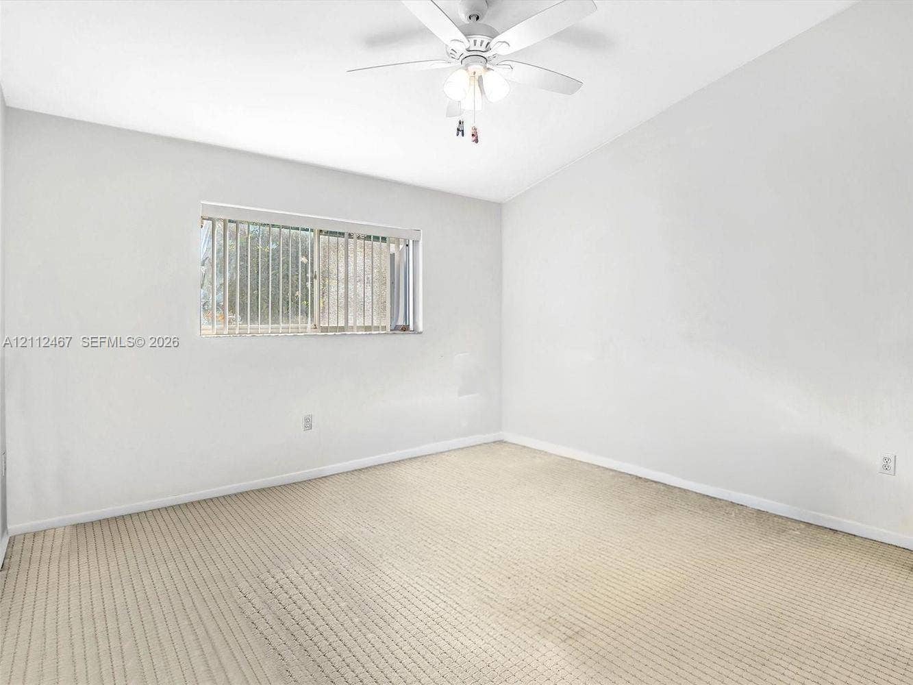 250 NE 212th Street, Miami, Miami, FL 33179 Neutral interior featuring carpeting, a vaulted ceiling, and a ceiling-mounted light fixture with a fan