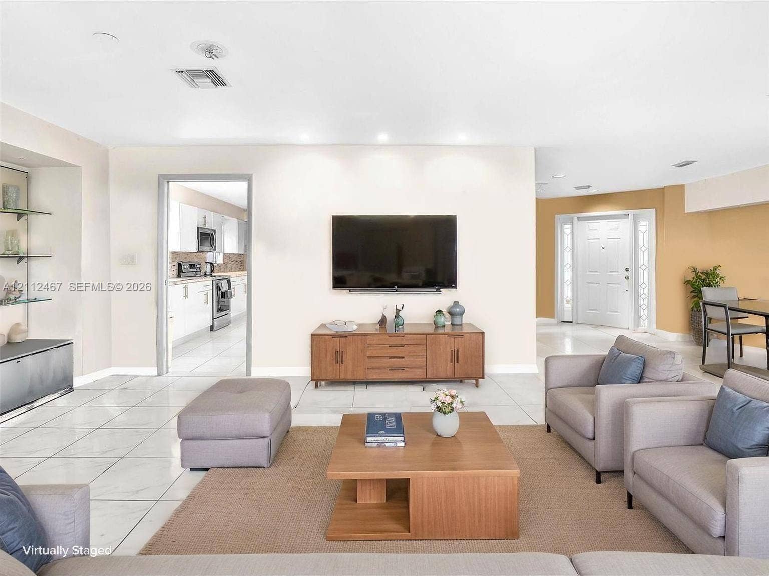 250 NE 212th Street, Miami, Miami, FL 33179 Open-concept living space featuring large-format tile flooring, recessed ceiling lighting, a built-in recessed shelving niche, and a multi-panel exterior entry door with glass side panels
