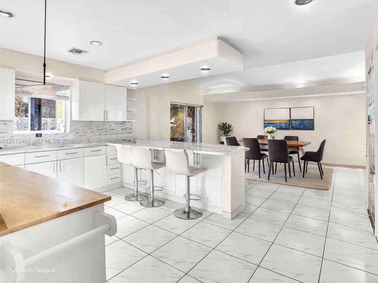 250 NE 212th Street, Miami, Miami, FL 33179 Kitchen featuring white cabinetry, stone-finish countertops, a tiered kitchen island, recessed lighting, and tile flooring