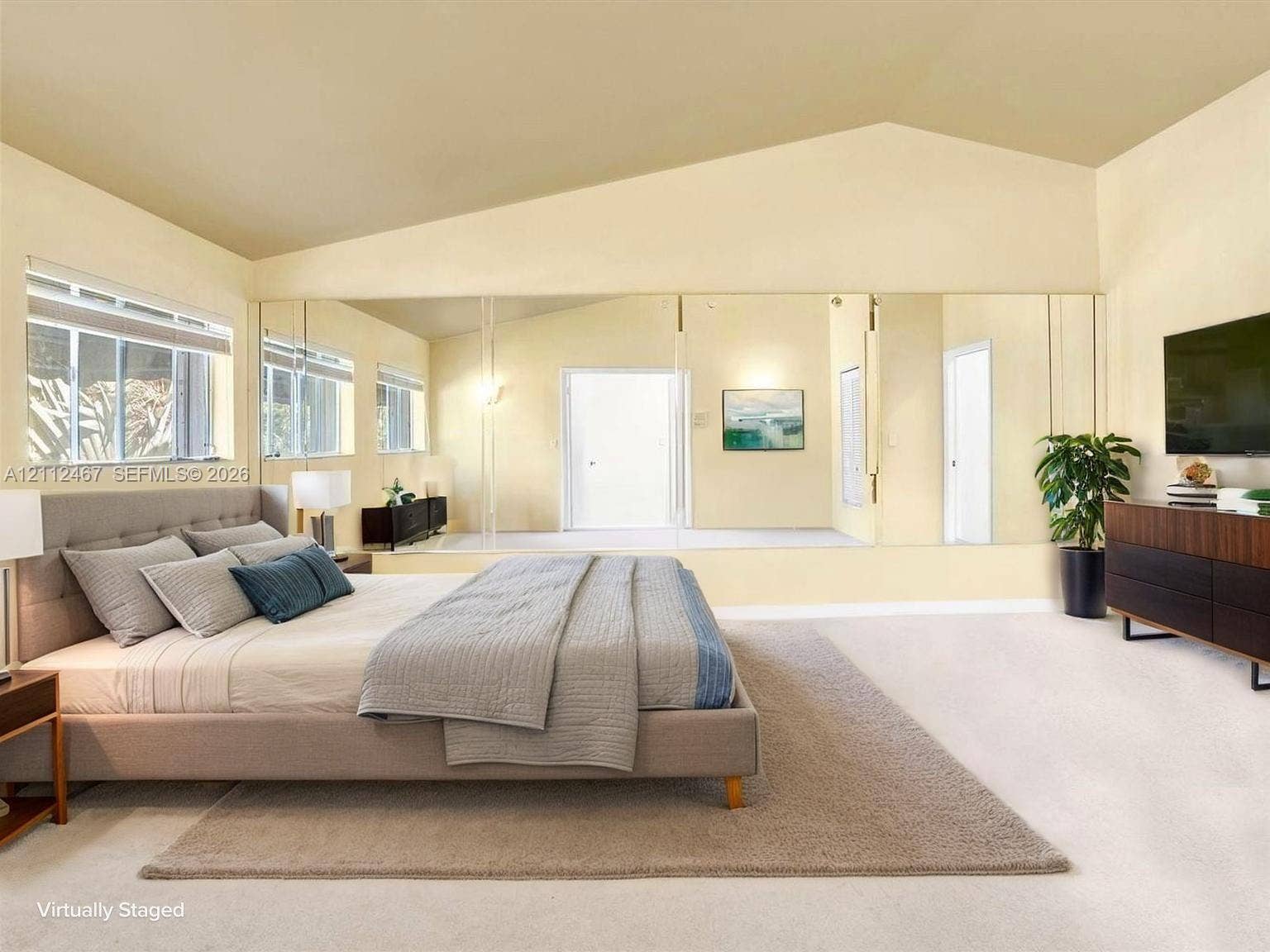 250 NE 212th Street, Miami, Miami, FL 33179 Vaulted ceiling, full-width wall mirror, and large windows with horizontal blinds