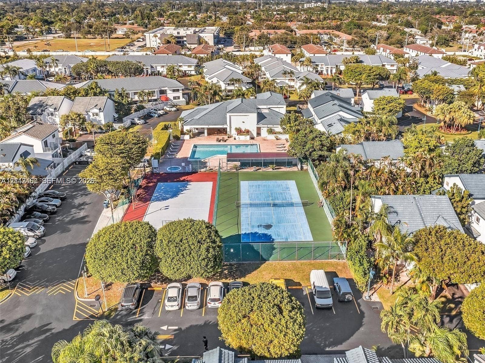 250 NE 212th Street, Miami, Miami, FL 33179 Community recreation area featuring a swimming pool, spa, fenced tennis court, and multi-purpose sports court