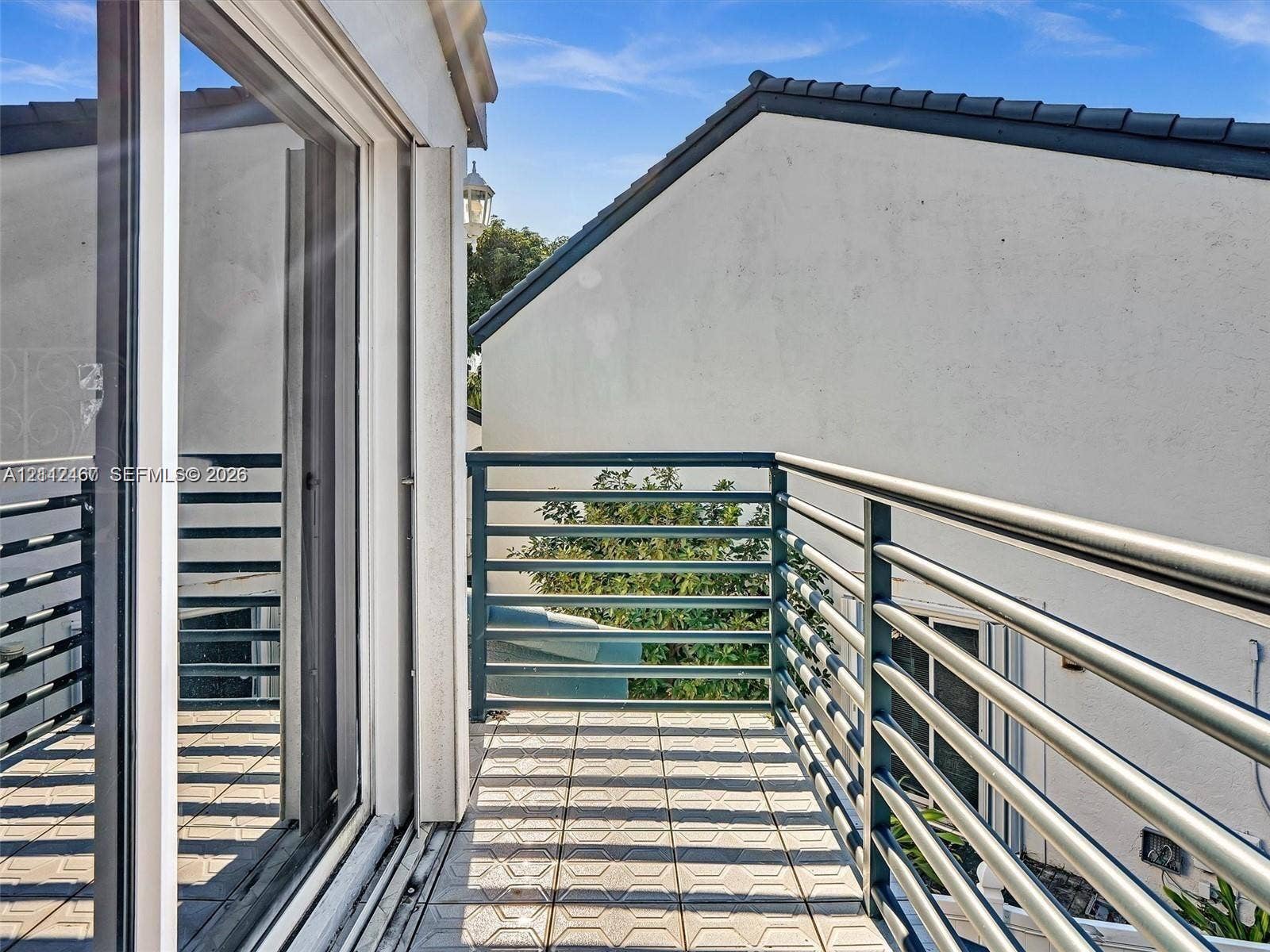 250 NE 212th Street, Miami, Miami, FL 33179 Balcony featuring square tile flooring and horizontal metal railings