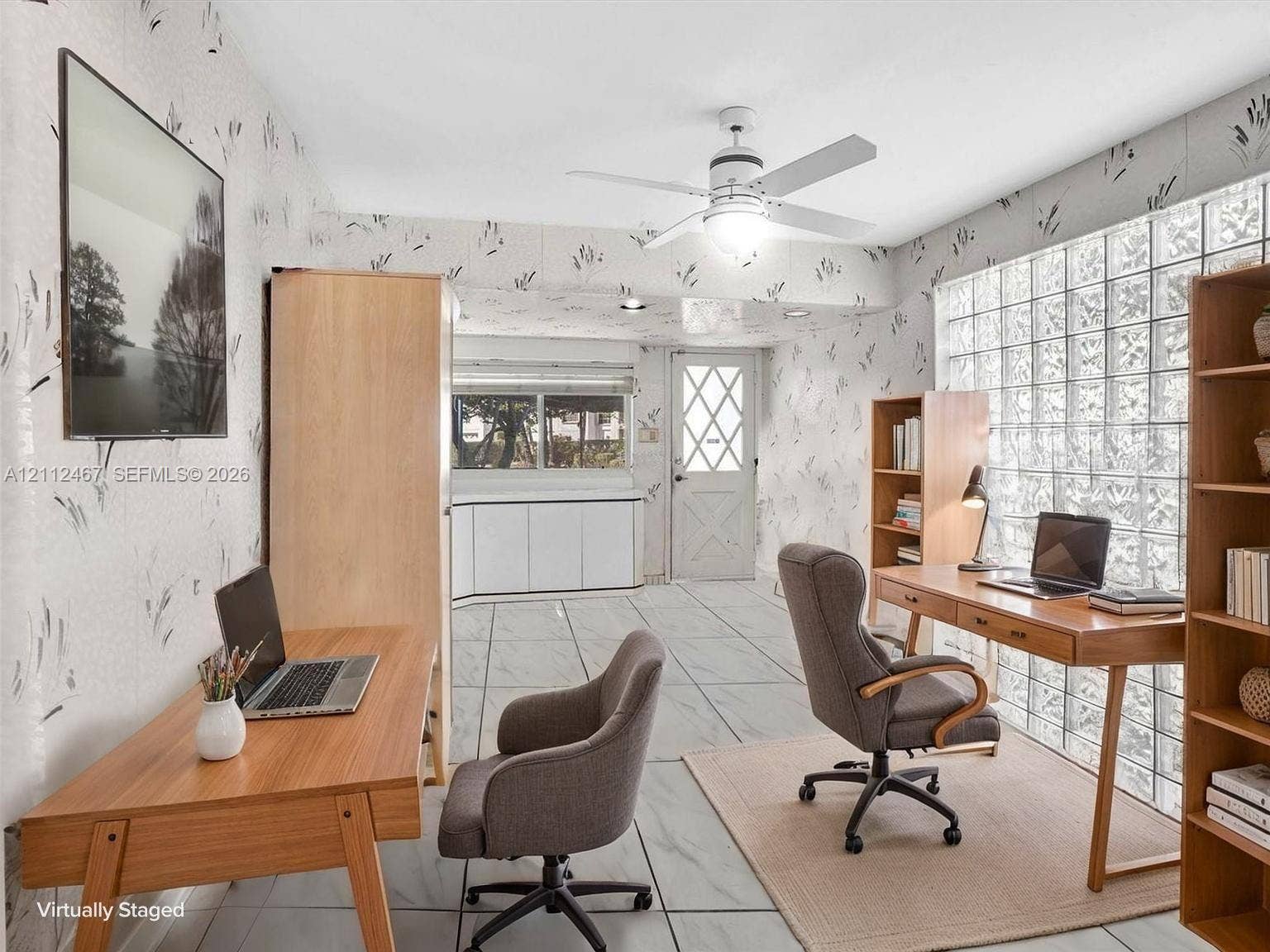250 NE 212th Street, Miami, Miami, FL 33179 Room featuring light-toned tile flooring, a grid-patterned glass block wall, and a ceiling fan with integrated lighting