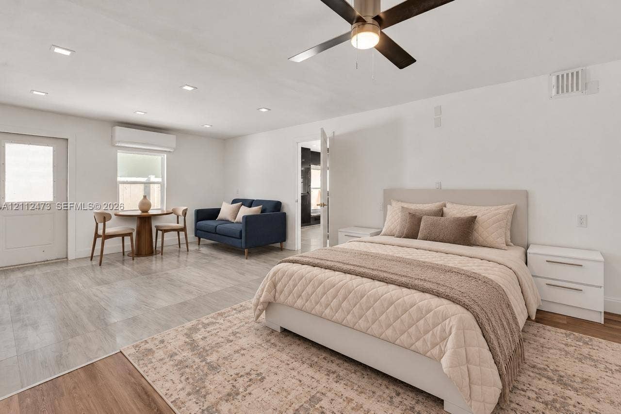 3340 SW 50th Street, Hollywood, Hollywood, FL 33312 Neutral-toned room featuring stone-finish flooring, recessed lighting, a modern ceiling fan, and a wall-mounted ductless heating and cooling unit