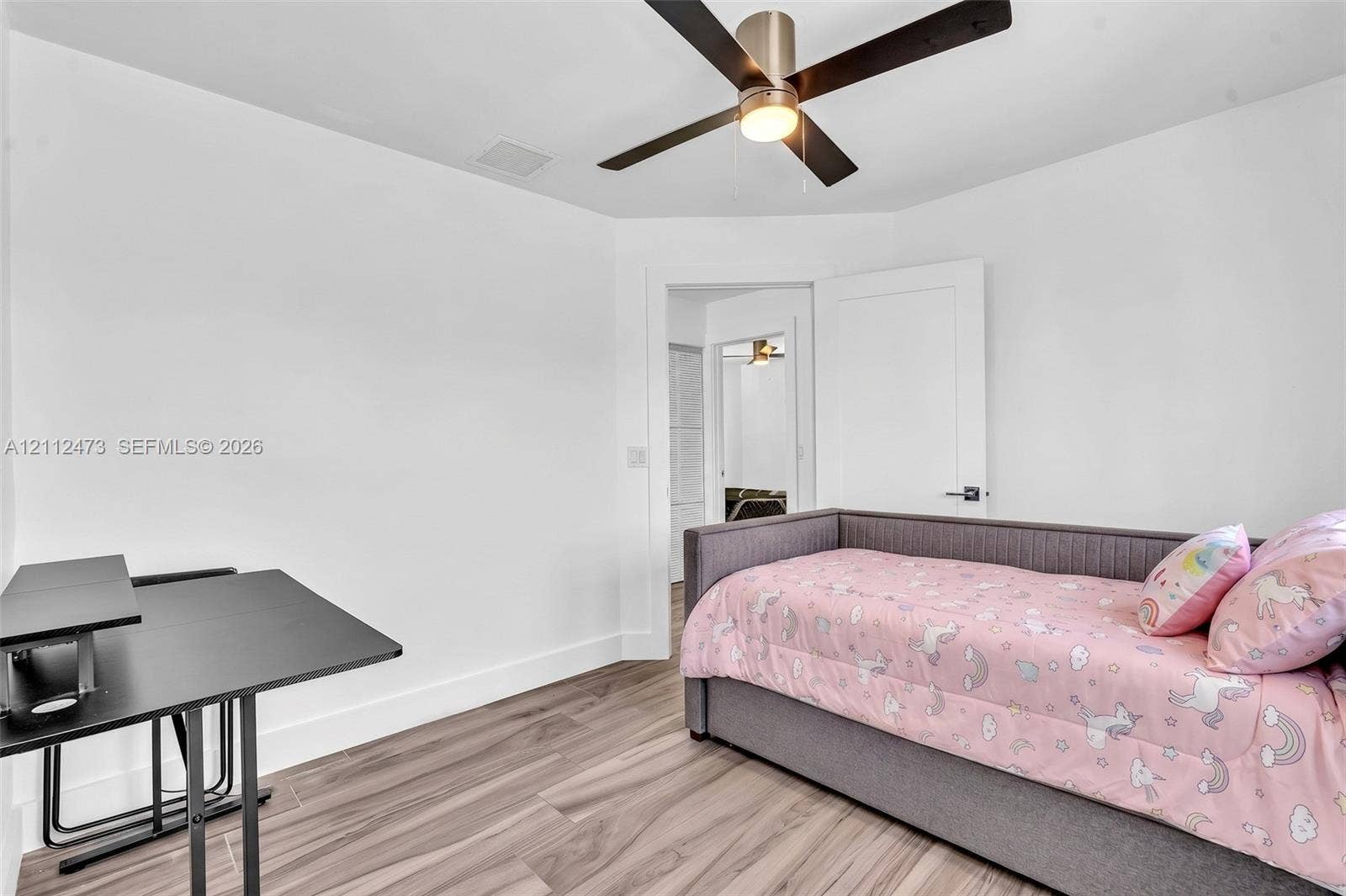 3340 SW 50th Street, Hollywood, Hollywood, FL 33312 Room featuring wood-finish flooring, white walls, and a ceiling fan with integrated lighting