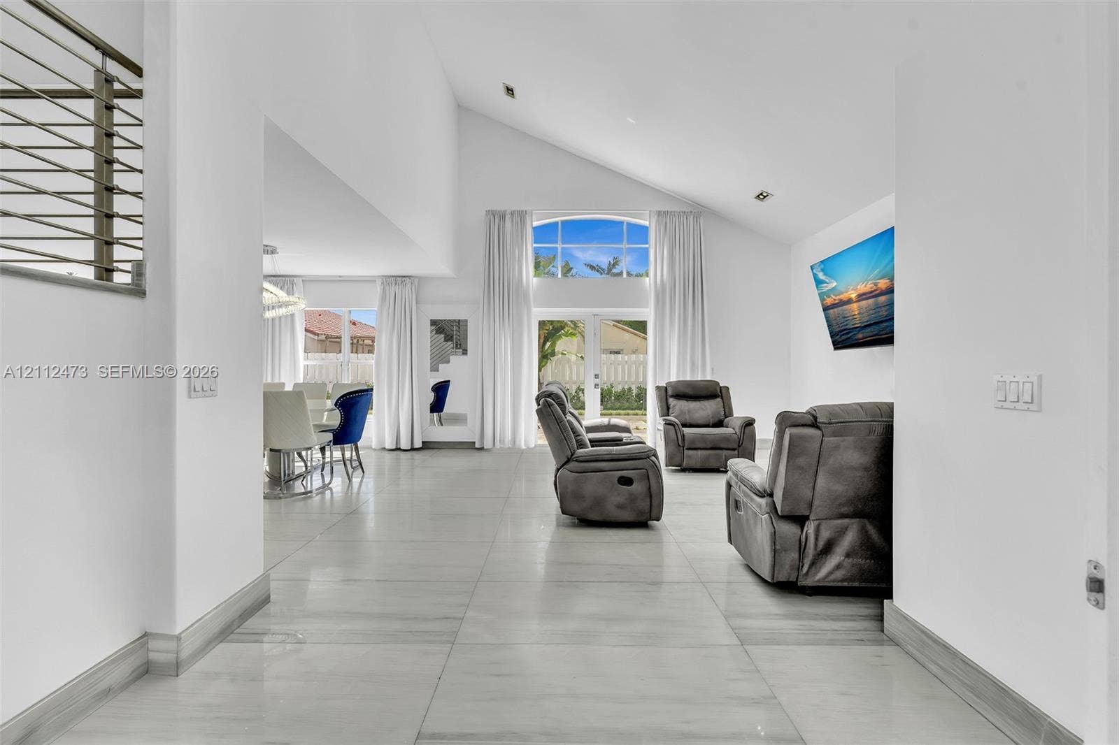 3340 SW 50th Street, Hollywood, Hollywood, FL 33312 Vaulted ceilings, large-format tile flooring, double-door glass entrance with arched transom window, and metal cable railing