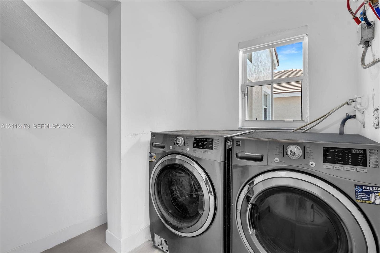 3340 SW 50th Street, Hollywood, Hollywood, FL 33312 Laundry area featuring a dedicated window with natural light and a recessed nook