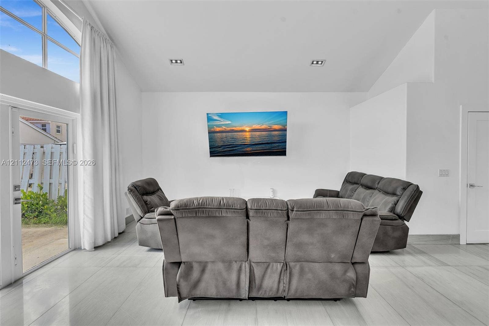 3340 SW 50th Street, Hollywood, Hollywood, FL 33312 Vaulted ceiling featuring recessed lighting, large-format tile flooring, and floor-to-ceiling windows with glass exterior door