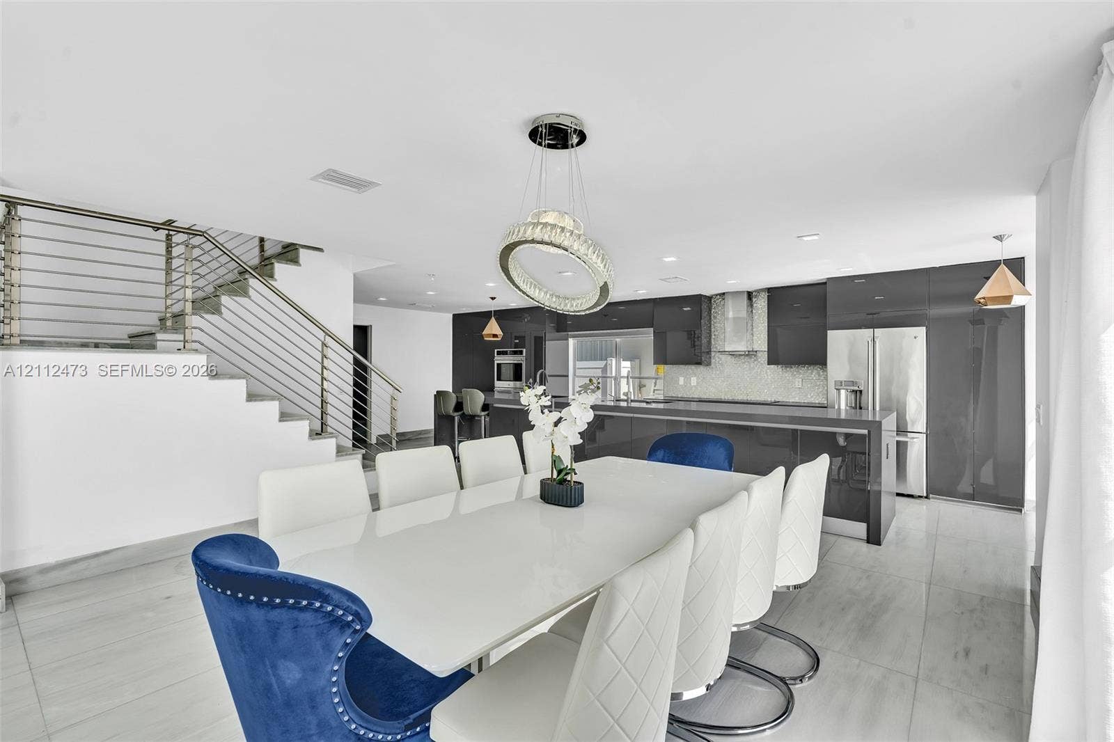 3340 SW 50th Street, Hollywood, Hollywood, FL 33312 Open-concept kitchen featuring high-gloss dark cabinetry, integrated stainless steel appliances, and tile flooring