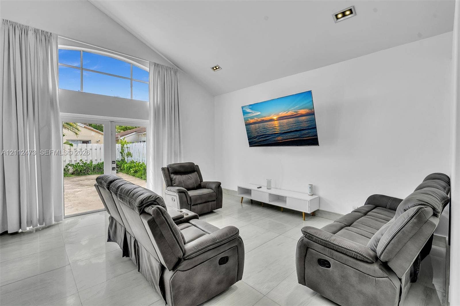 3340 SW 50th Street, Hollywood, Hollywood, FL 33312 Vaulted ceilings, large-format tile flooring, recessed lighting, and expansive floor-to-ceiling glass panel doors