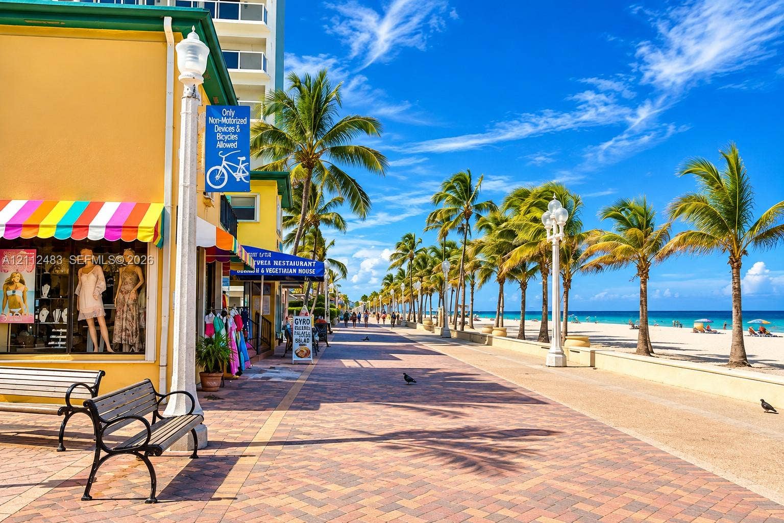 3505 S Ocean Drive, #1101, Hollywood, FL 33019 Paved brick promenade featuring ornate street lighting, mature palm trees, and direct access to a sand beach